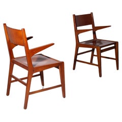 Pair of wooden chairs with armrests