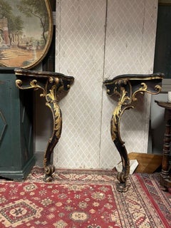 Pair of wooden consoles, corner shelves, lacquered with gold decorations, Italy