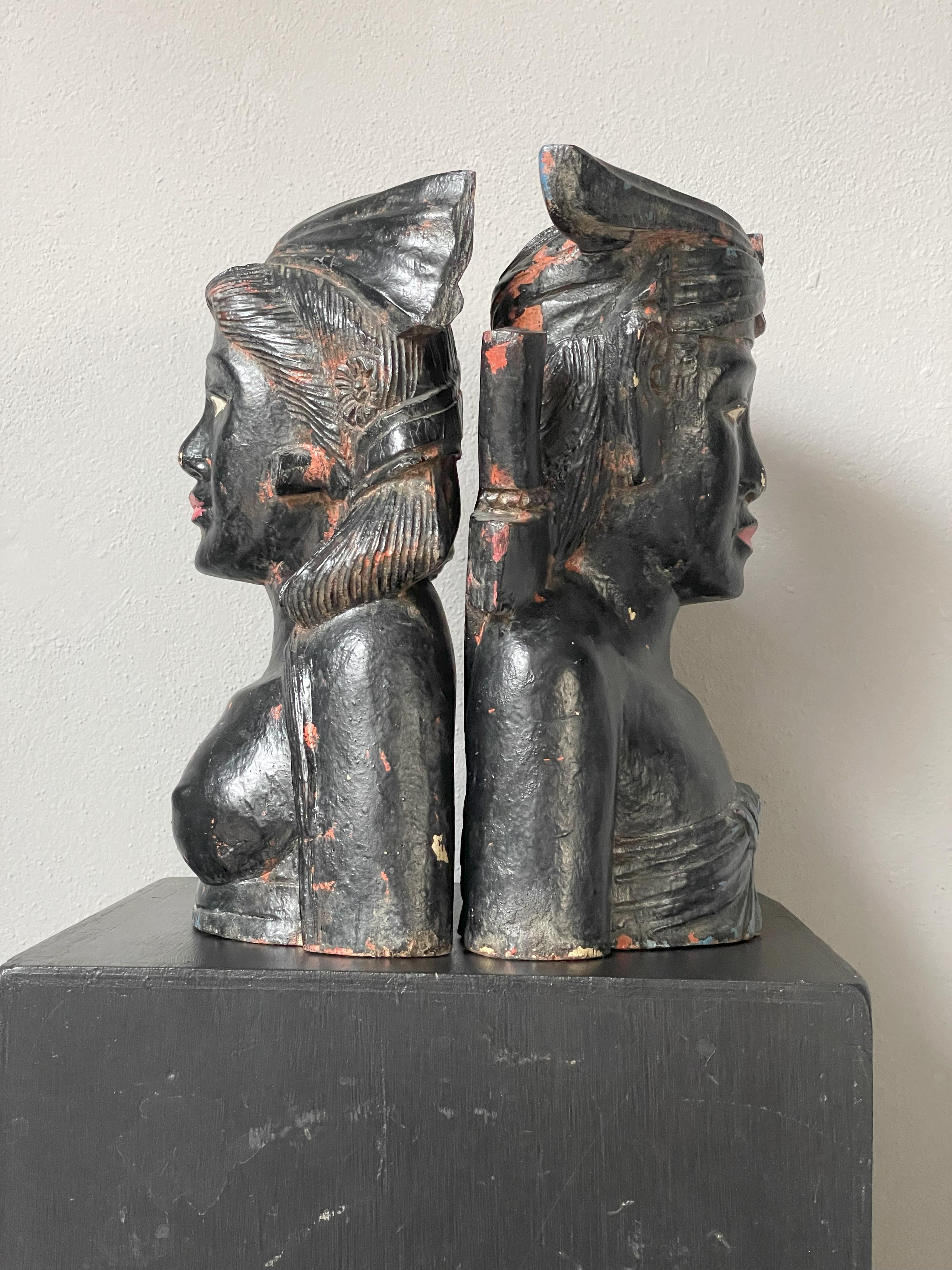 Two beautiful sculptures made of wood and painted black.