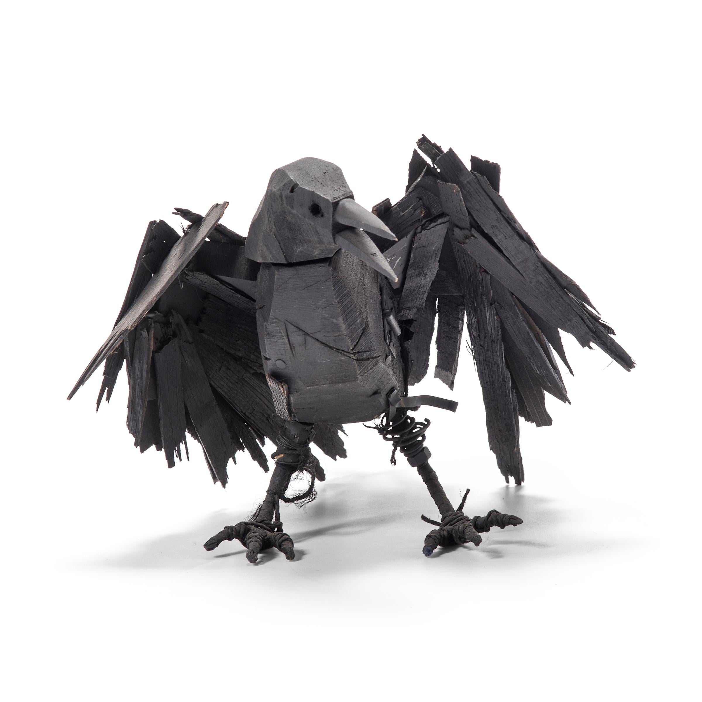 Richly textured with a haphazard appeal, these wooden crow sculptures are a delightful example of American folk art. Poised mid-caw, the crow's wings are outstretched, ready to burst into flight. As though life materialized from a pile of scrap wood