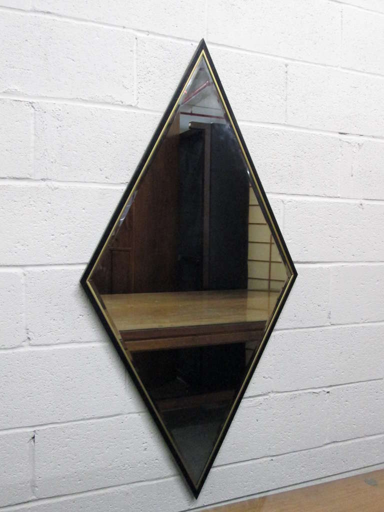 Pair of diamond mirrors with black lacquered wood frame and brass trim. Mirrors are beveled. Hollywood Regency.

 