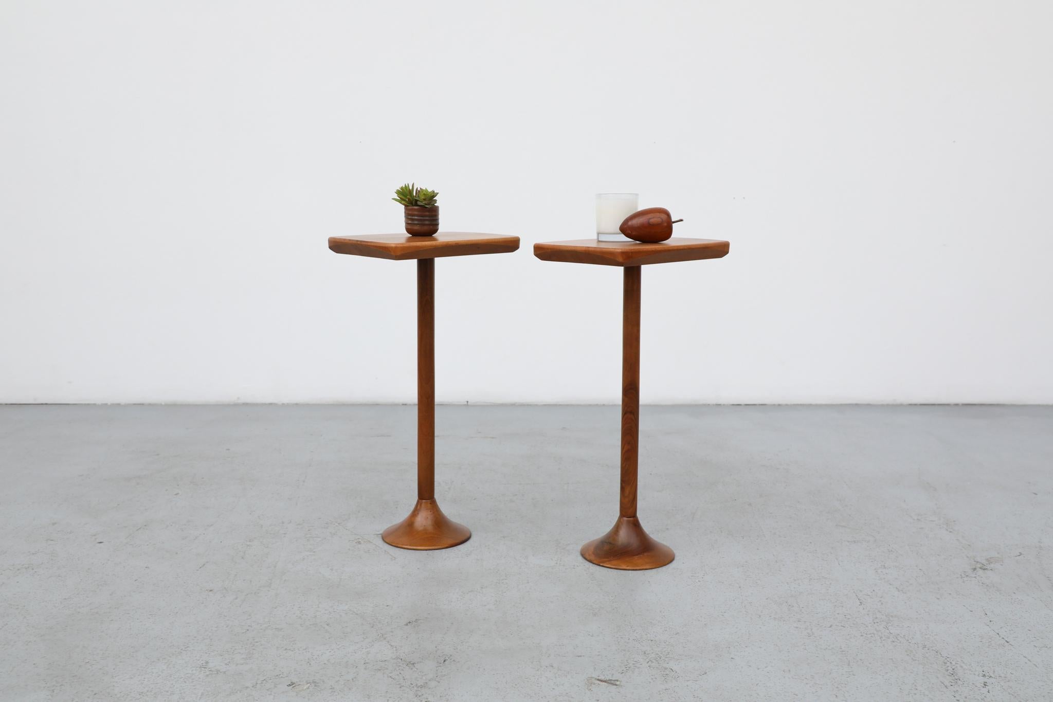 Pair of petite pedestal side tables with sleek design and minimalist style. Rectangular tops with soft edges that effortlessly flows into its tulip base. Lightly refinished with beautiful wood grain pattern these light Italian side tables are