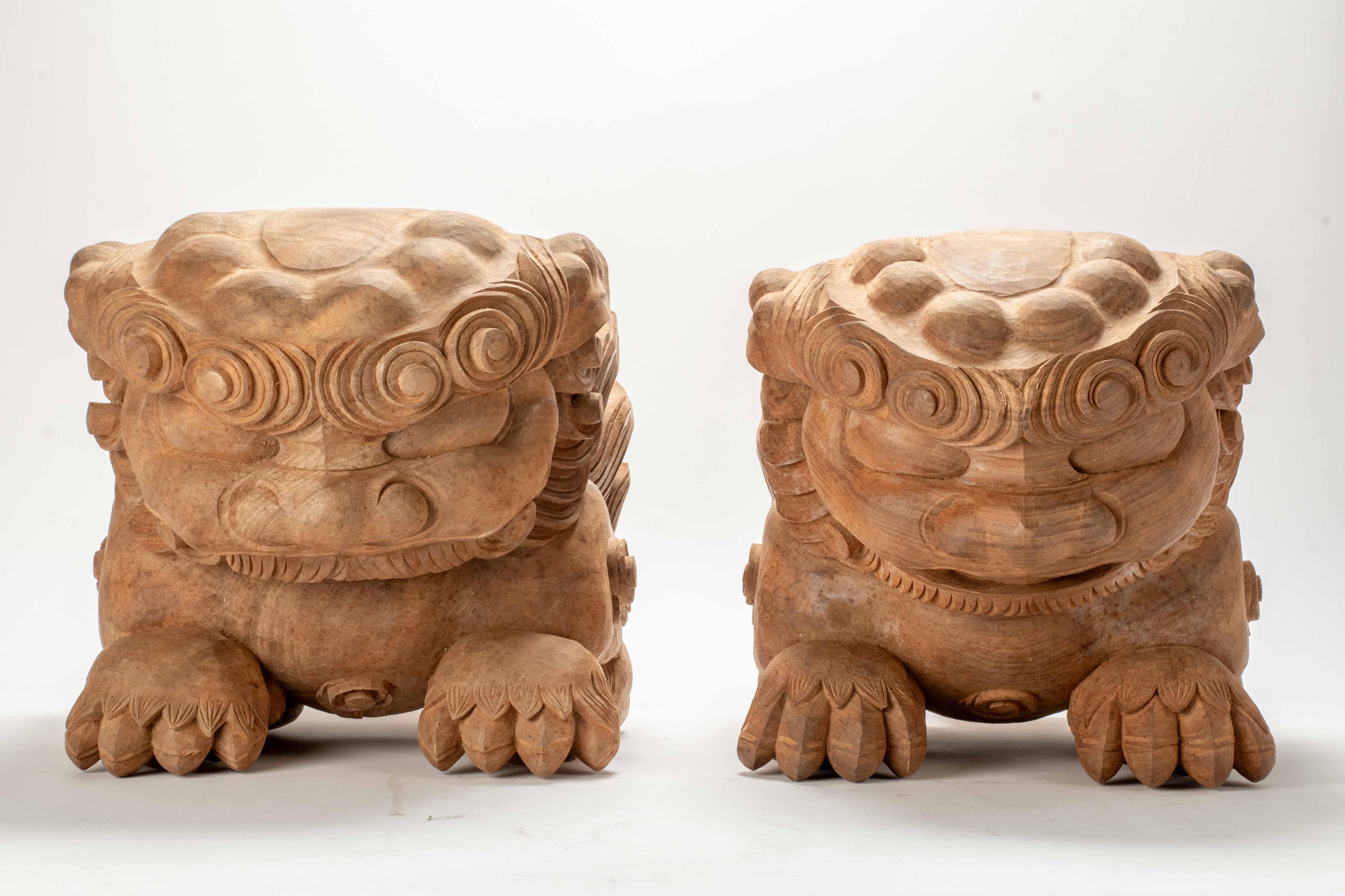 Pair of large kibana, carved wooden ornaments used in Japanese Buddhist temples, carved in the shape of mythical lion-like creatures, called shishi. Shishi are depicted with dynamic expressions and vigorous postures, ready to defend the temple from
