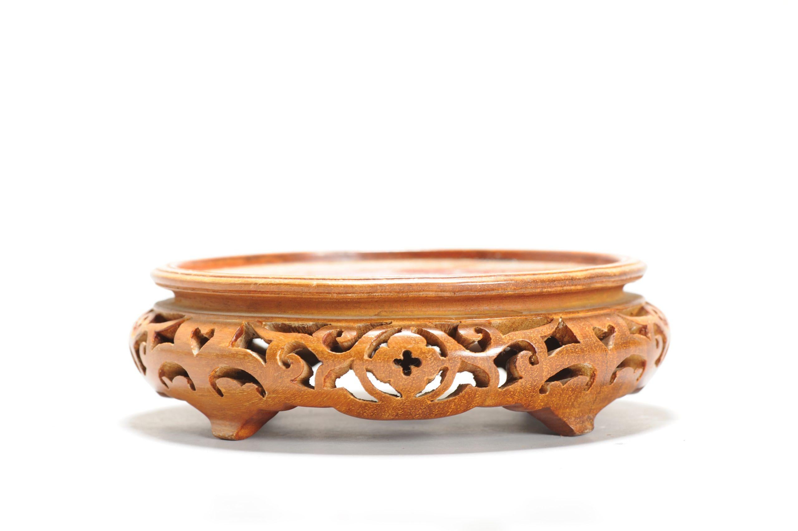 Here we have a nice wooden plate stand

Additional information:
Region of Origin: China
Material: Porcelain & Pottery
Period: early to mid 20th c
Condition: Very good condition
Dimensions: The size of the usable surface: 13cm