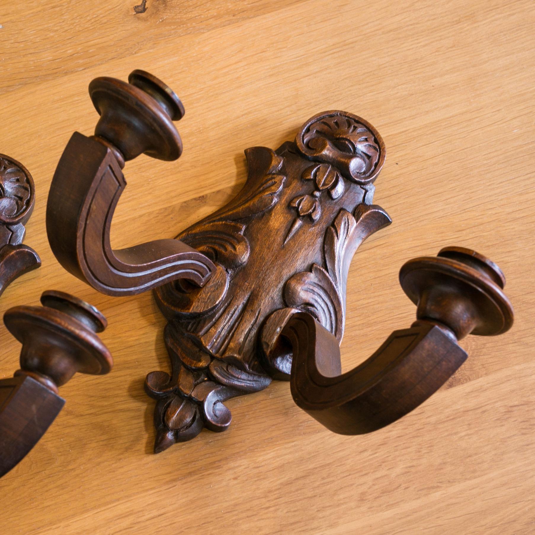 Pair of wooden two-arm sconces carved in Louis XVI style. These vintage French sconces can be used with candles and are currently not wired. Can be wired for an additional cost. Sold together as a pair for $950.