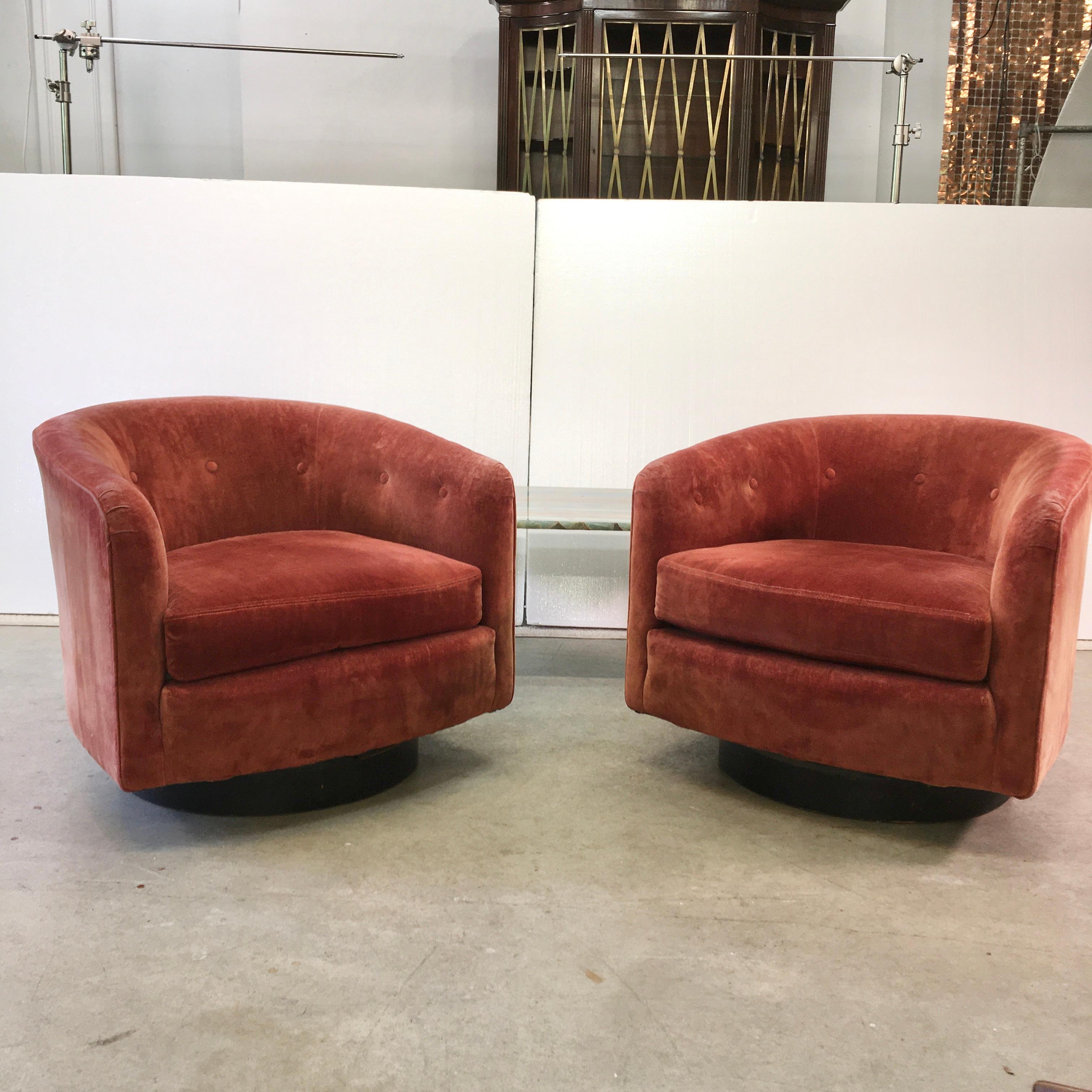 Presented for reupholstering, pair of petite barrel back swivel chairs on black wood plinth base. Original cola red velvet upholstery with button tufts and reversible seat cushion. Labeled Woodmark Originals.
See original vintage ad from The South