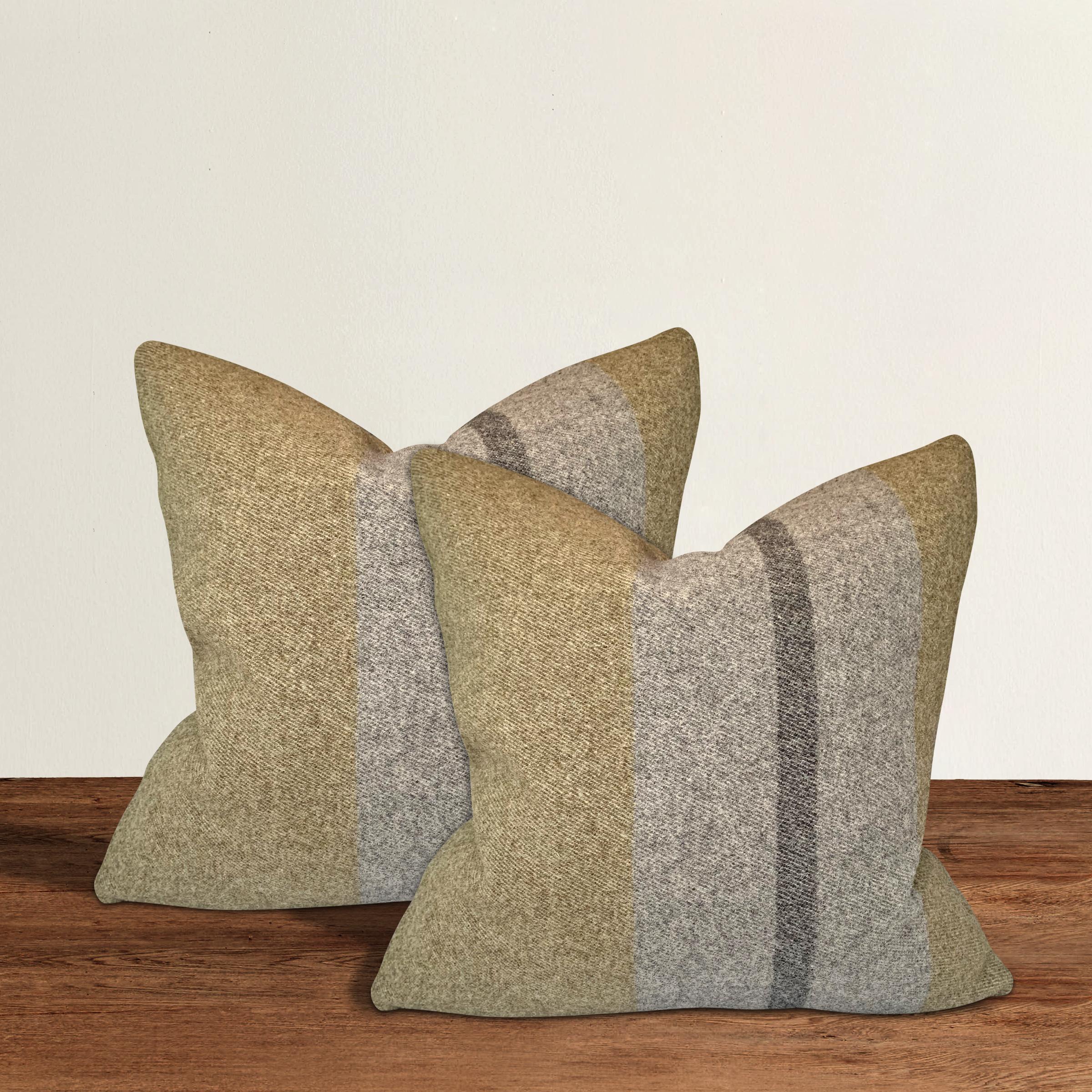 A wonderful pair of pillows with gray and black stripe against an army green ground, custom made from wool sourced from the Faribault Woolen Mills in Faribault, Minnesota. Faribault Woolen Mills was founded in 1865 along the Cannon River in