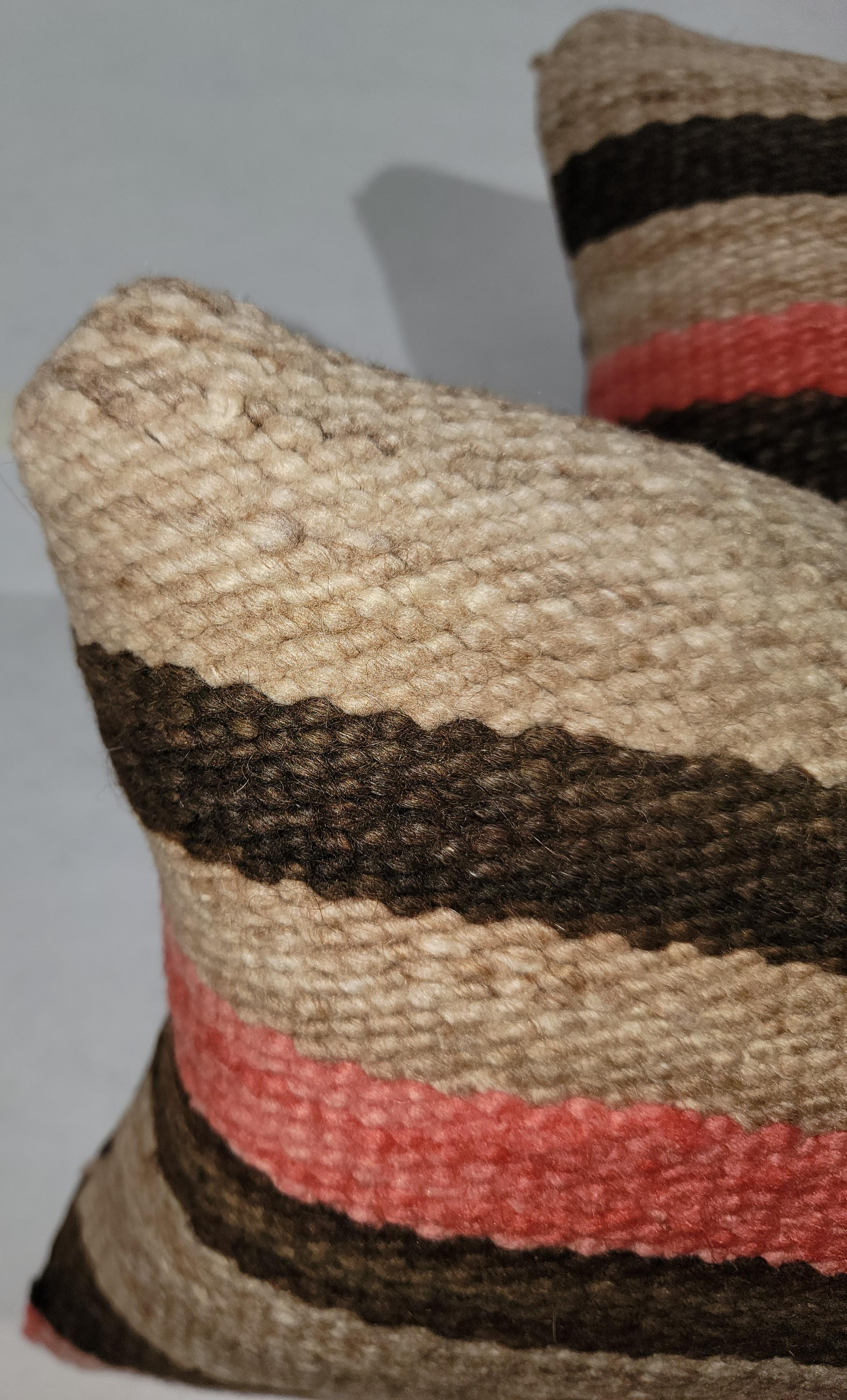 Pair Of Wool Striped Saddle Blanket Pillows.
Brown linen backing compliments the chosen saddle blanket colors. This saddle blankets has been professionally laundered. There is a custom down and feather made insert for each pillow. 