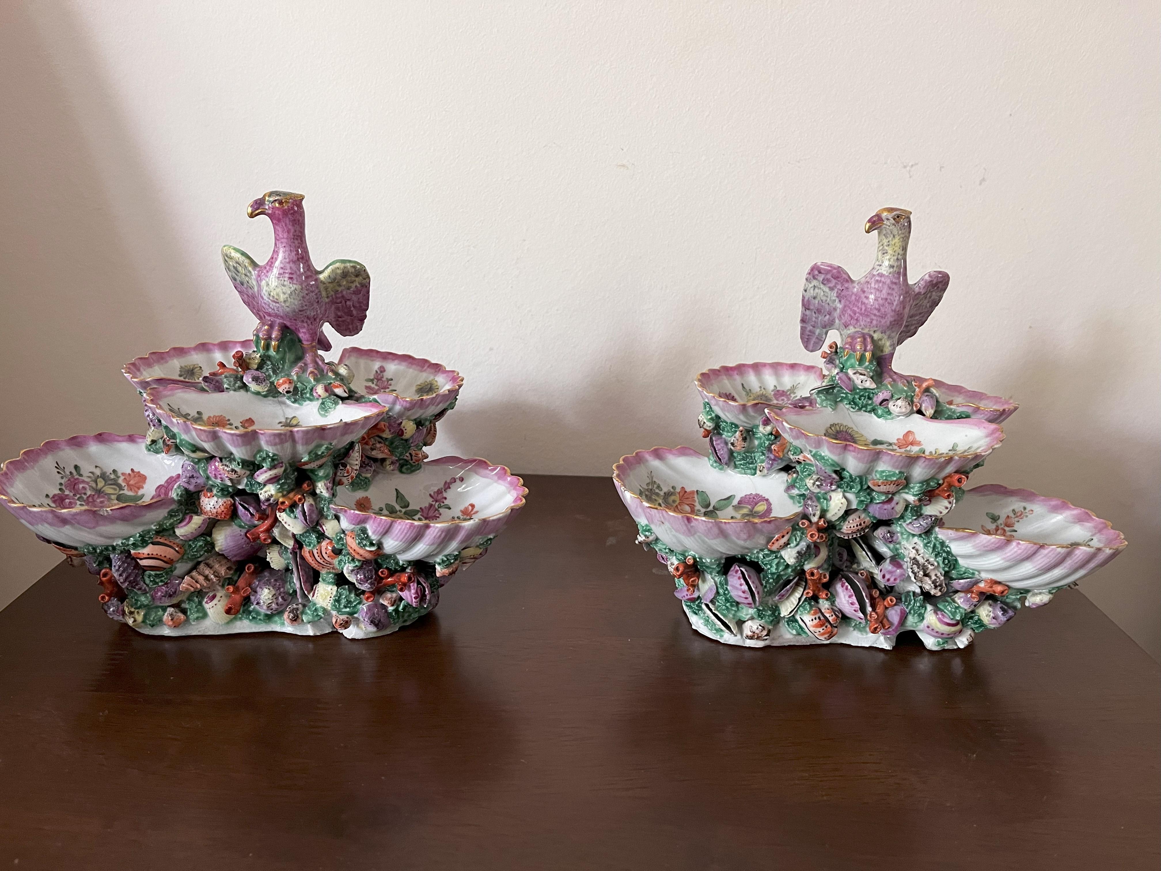 A pair 18th Century Worcester Porcelain Shell Centrepieces, circa 1770, each modelled as six shells on a base of smaller shells and coral, painted with flower sprays within pink borders, topped with an Eagle with outstretched wings that acts as a