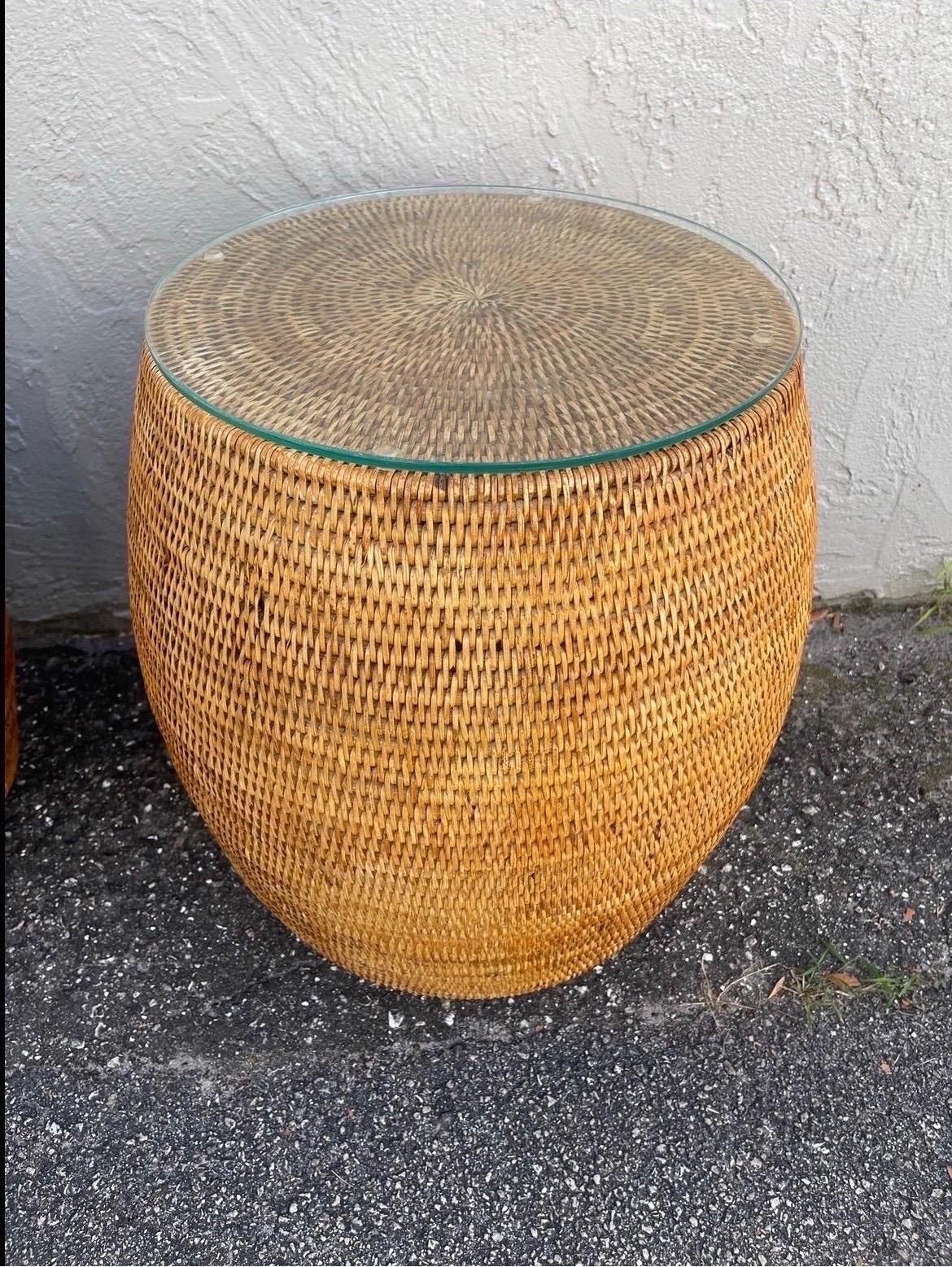 Pair of natural woven bamboo garden stools with glass tops. These lovely stools have a variety of uses.  With the glass they make great drinks / side tables.









