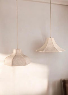 Pair of woven embroidered raffia pendants, France, 1960s