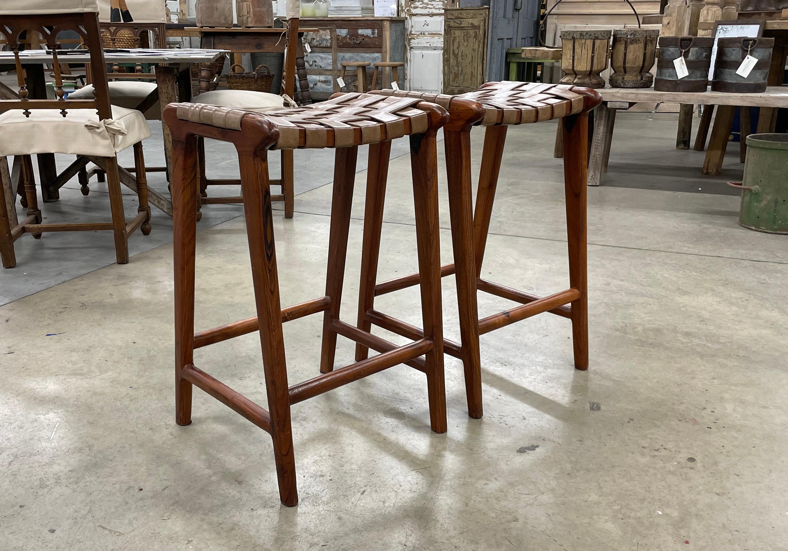 Pair of Mid-Century style backless woven leather stools. Perfect for bars or counters at 26.0