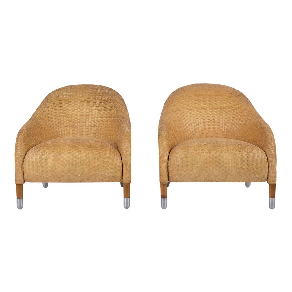 This pair of contemporary club chairs are in good condition, finely crafted, and completely covered in woven strapped leather over medium-form foam inserts. These Armchairs feature a curved back design, deep seats making them very comfortable, and