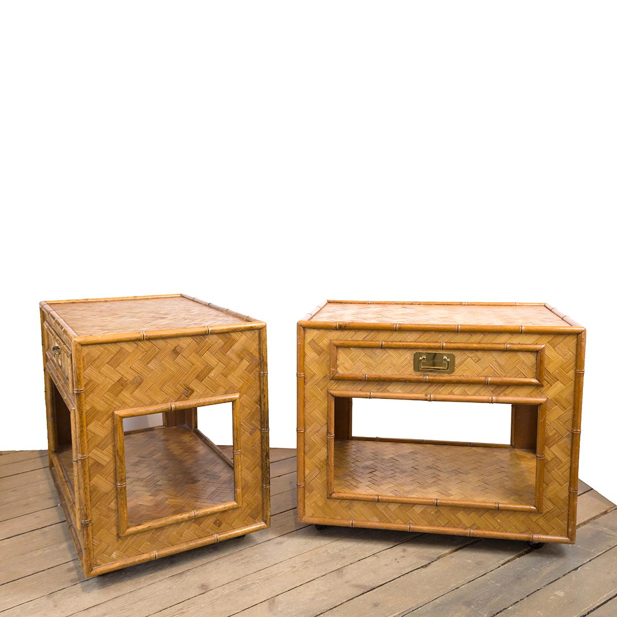 Pair of woven rattan cabinets with single drawer, bottom shelf, brass hardware and
casters.