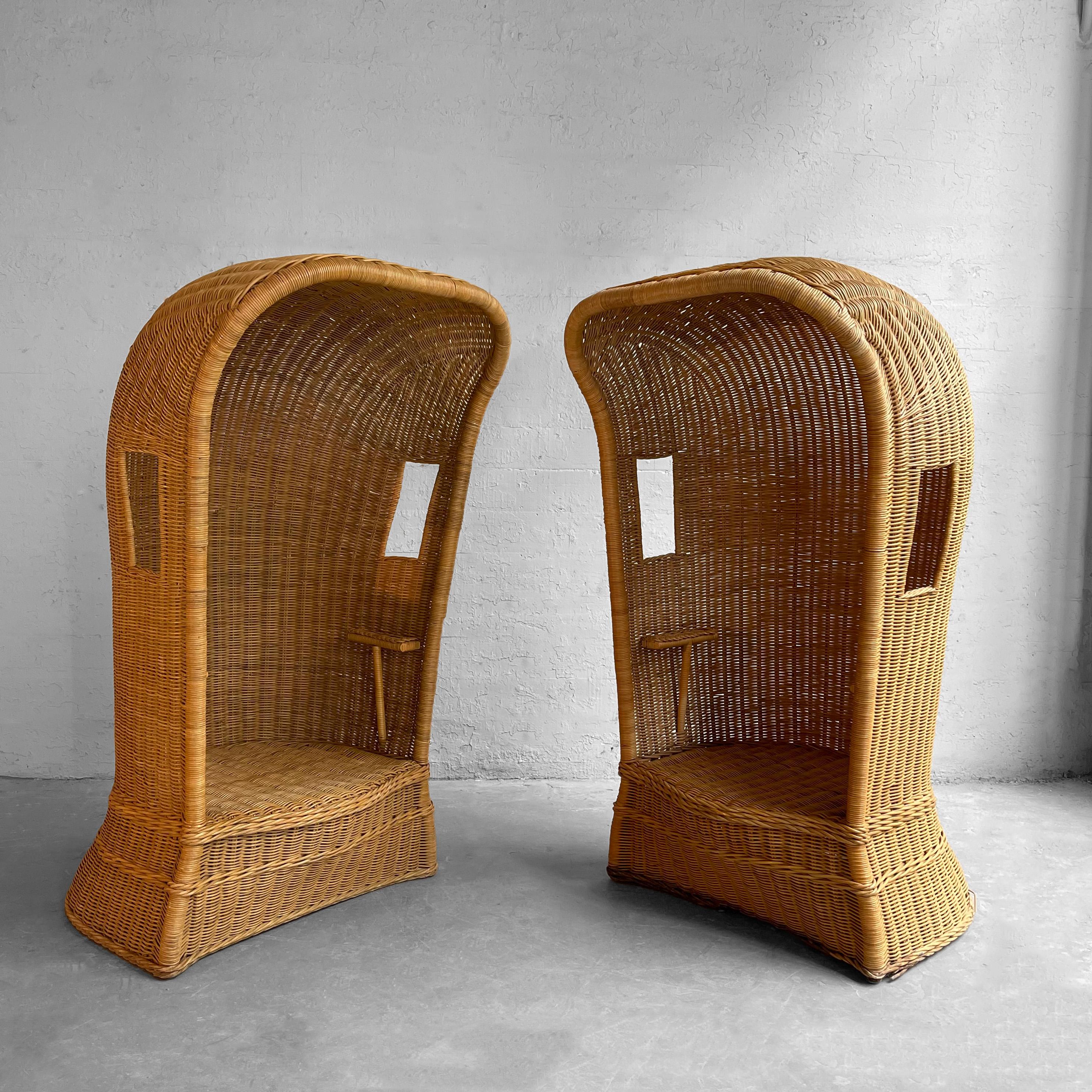 Pair of mid-century, Victorian style, tall, woven, wicker, porter's chairs feauture hooded coverings with 
