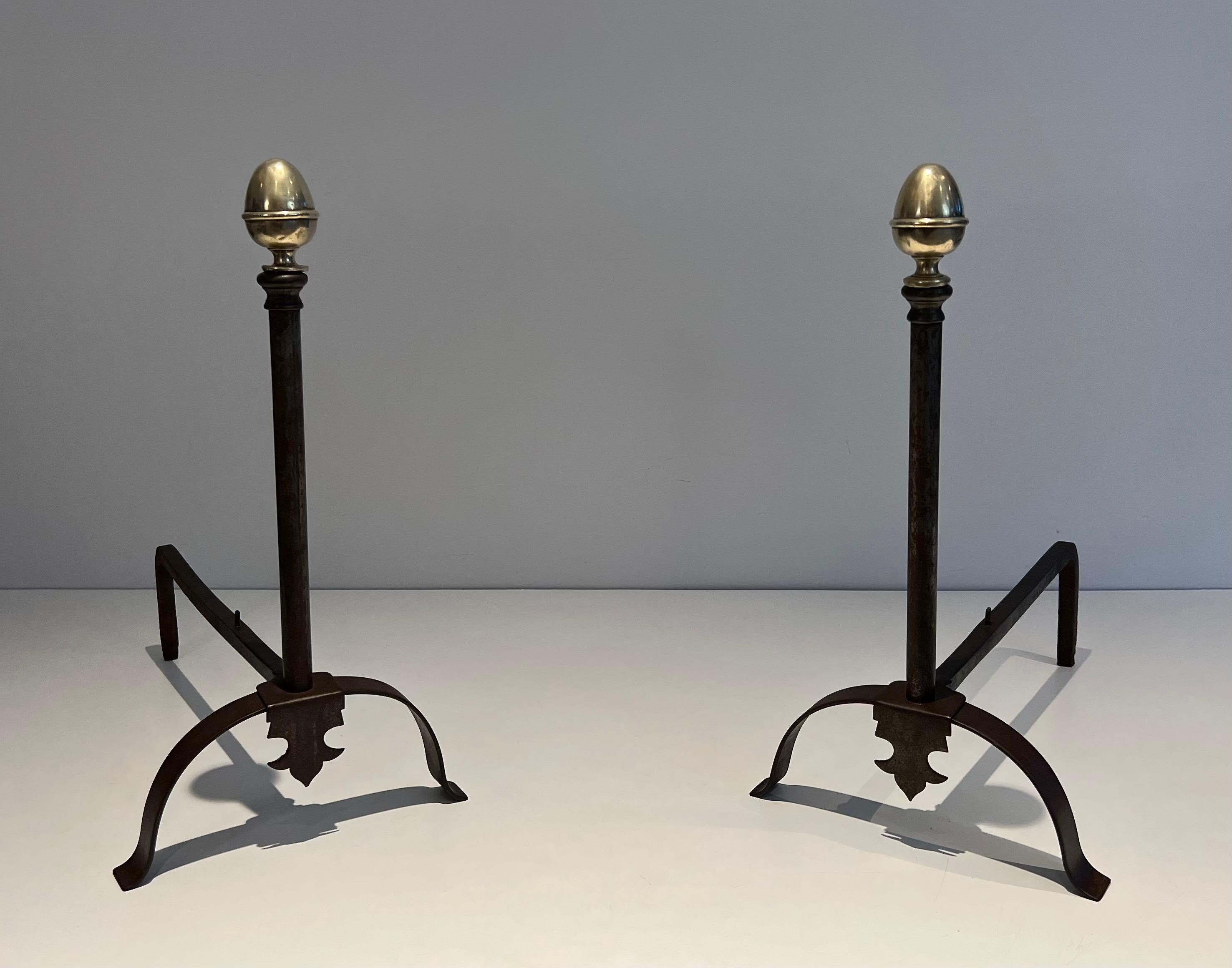This pair of andirons is made of wrought iron and brass. This is a French work. Circa 1850