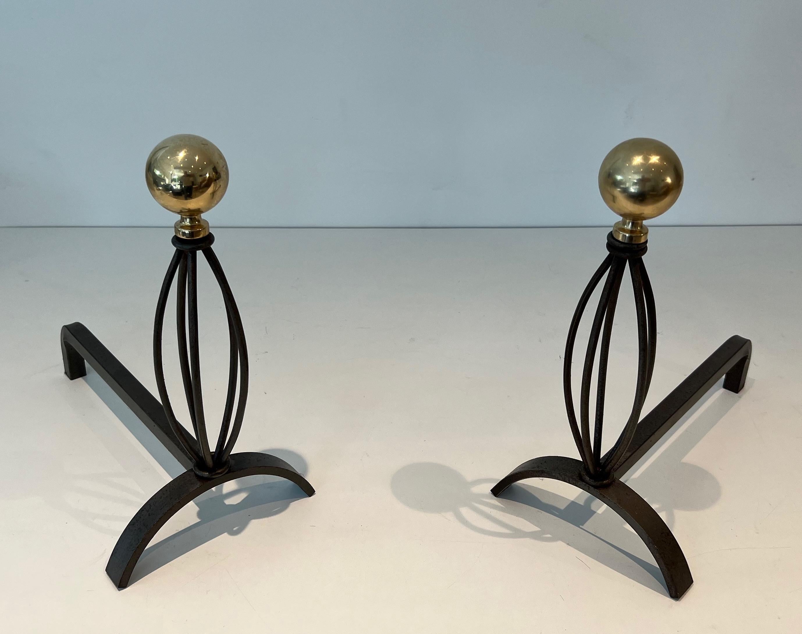 This pair of decorative andirons aere made of wrought iron and brass. This is a French work. Circa 1970