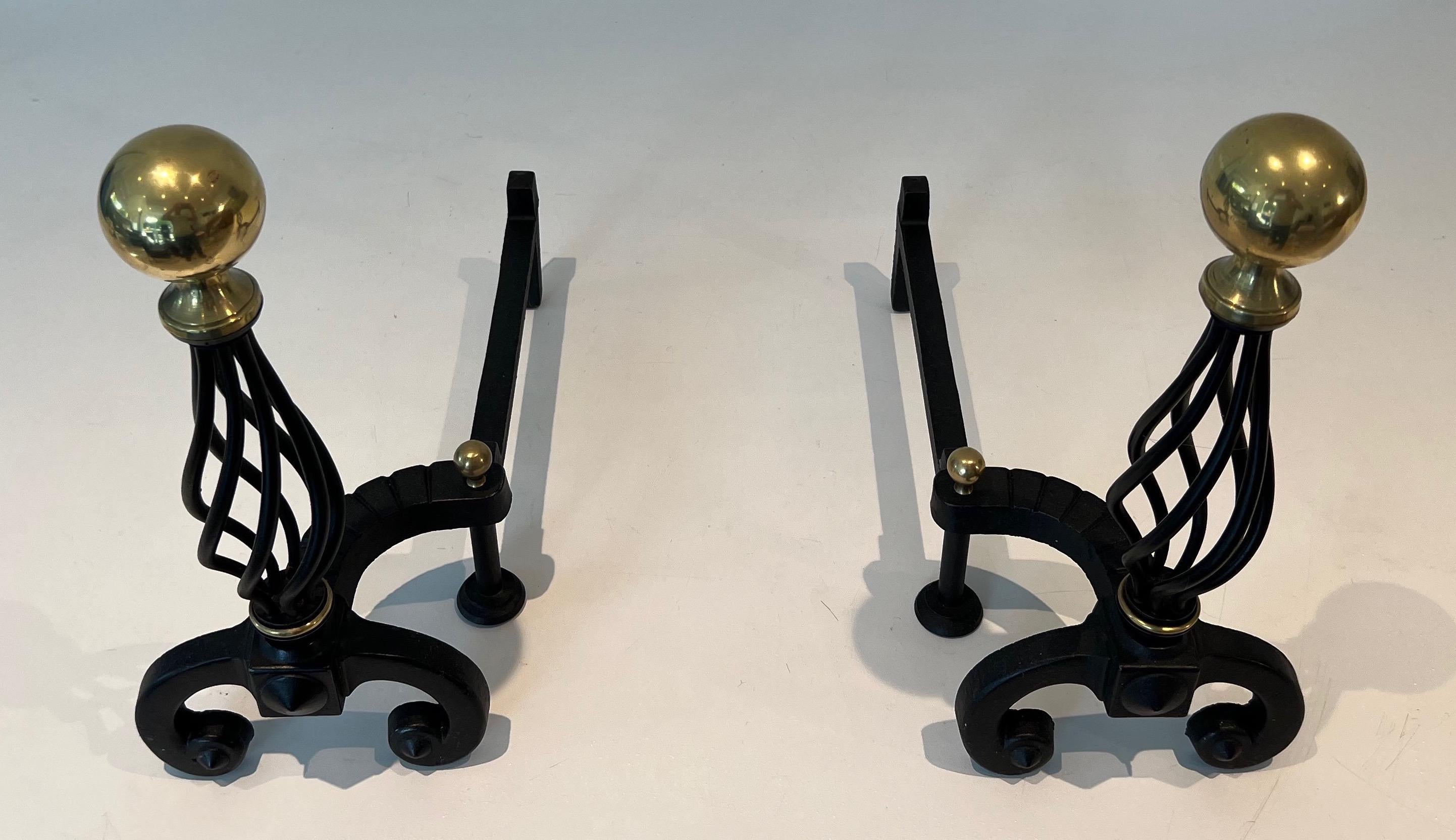 This pair of andirosn is made of wrought iron and brass. This is a French work. Circa 1970