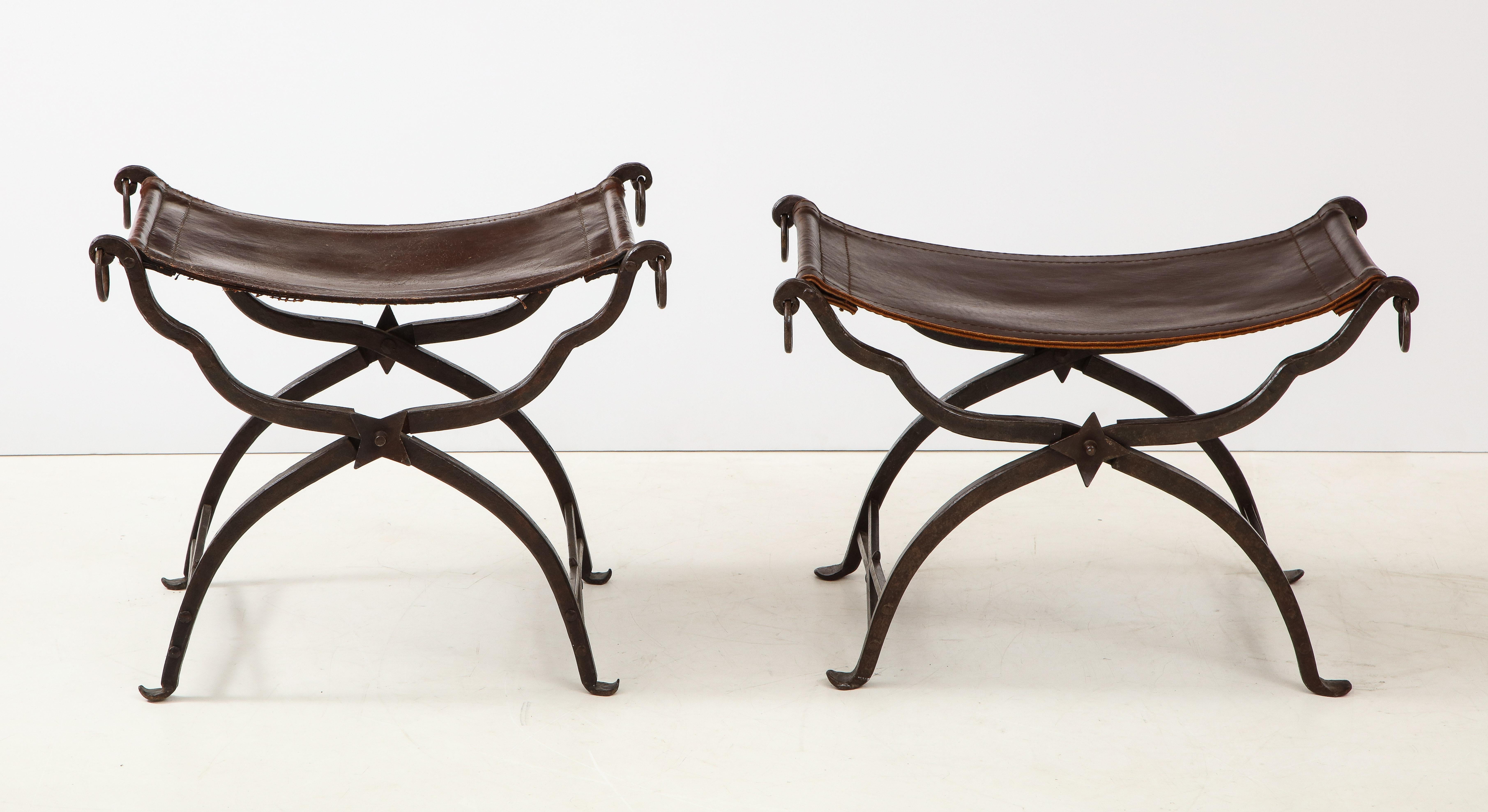 Pair of wrought iron and stitched leather curule stools by Morgan Colt.
  