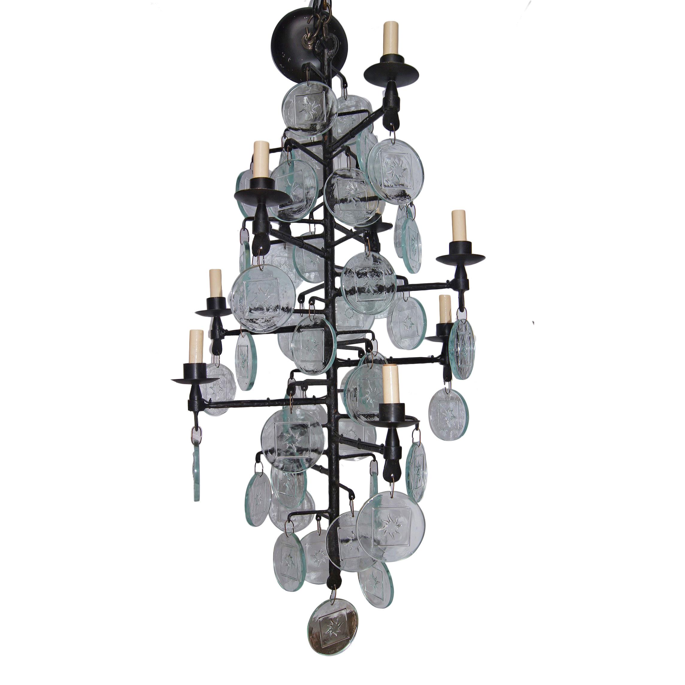 Pair of circa 1950's Swedish wrought iron and molded glass chandeliers, wired for electricity. 
Sold individually.

Measurements:
Min. drop: 47