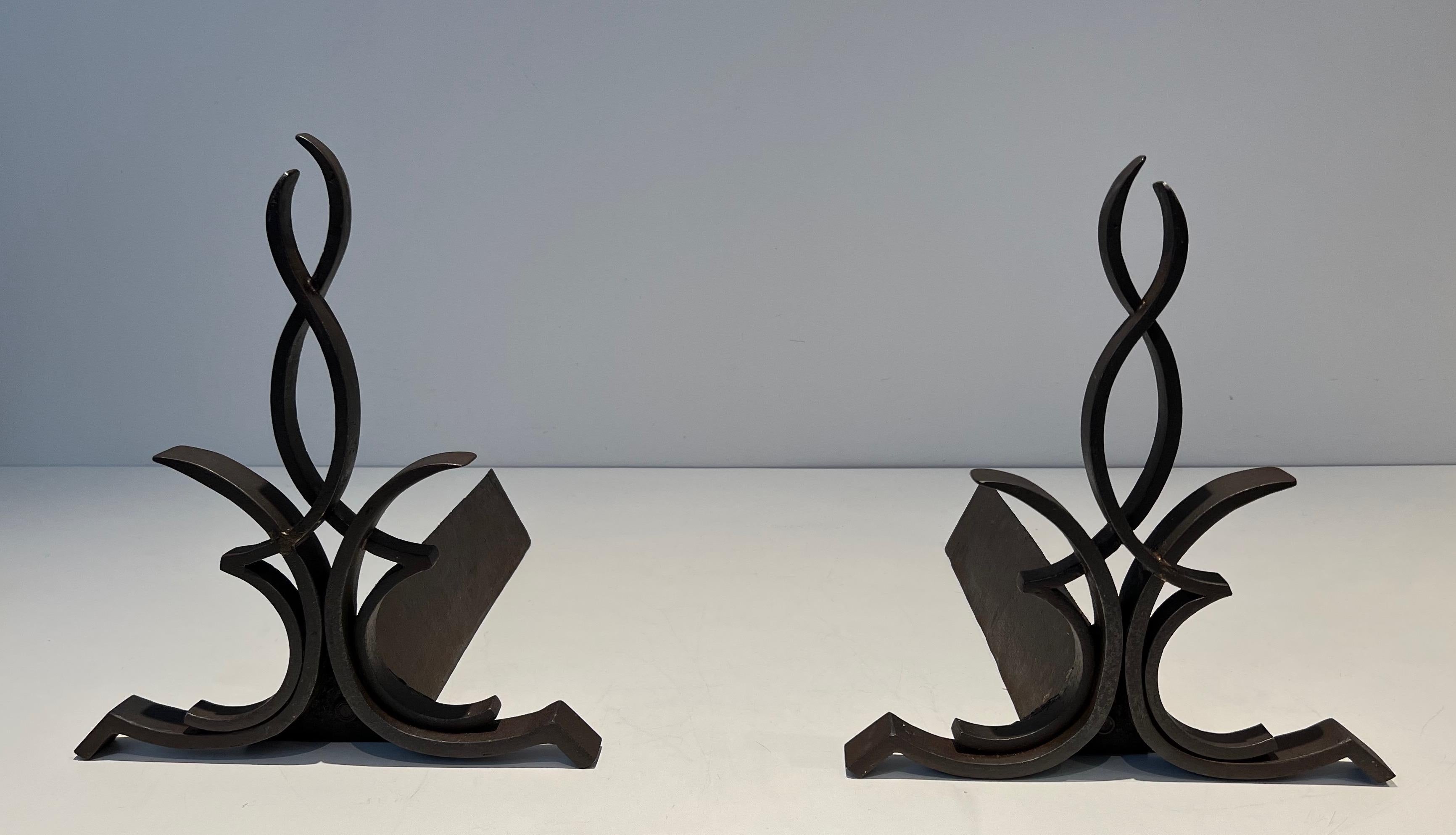 This pair of andirons is made of wrought iron and cast iron. This is a French work by Rfamous designer aymond Subes. Circa 1940.