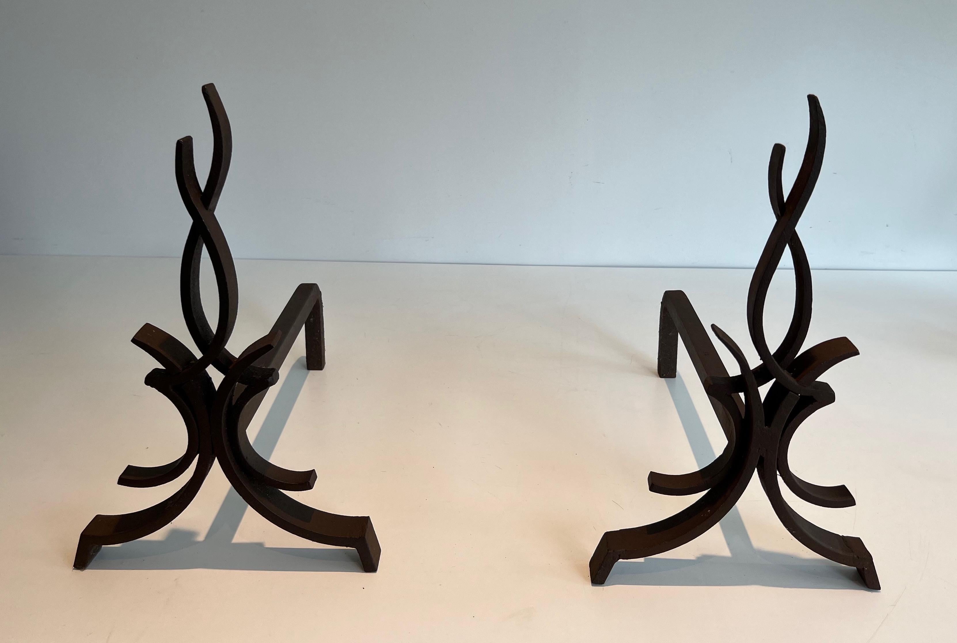 This very nice pair of andirons is made of wrought iron. This is a very fine French work by famous designer and iron maker Raymond Subes. Circa 1940