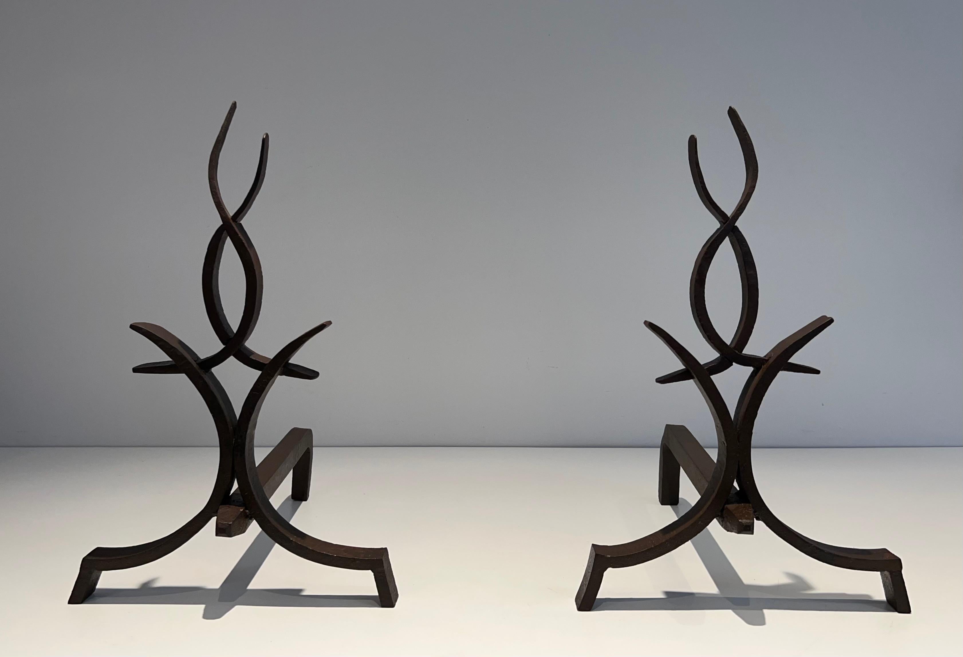 This very nice, fine and elegant pair of andirons is made of wrought iron. This is a French work by Raymond Subes. Circa 1940