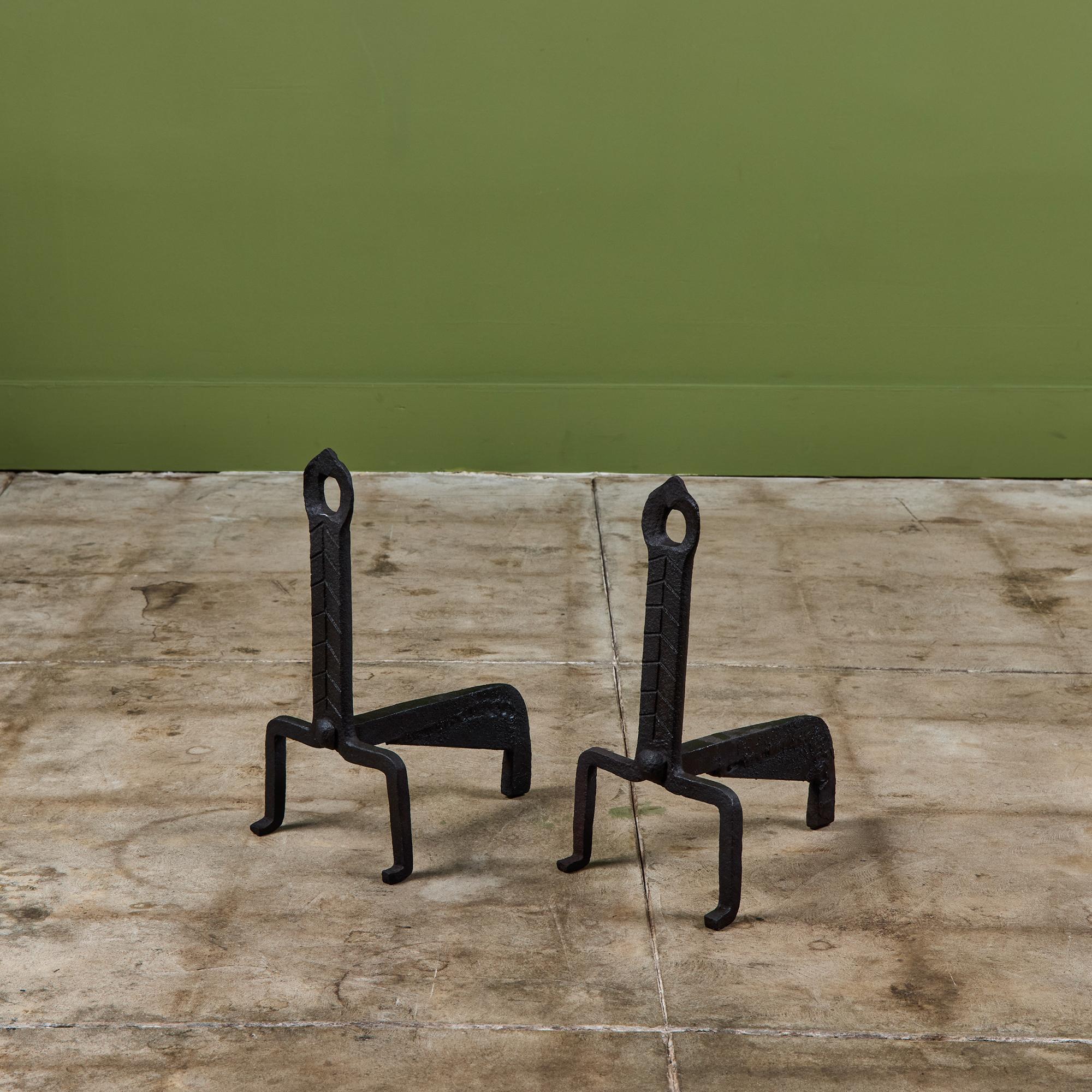 Pair of wrought iron andirons featuring a feather motif and curved feet.

Dimensions
7.75