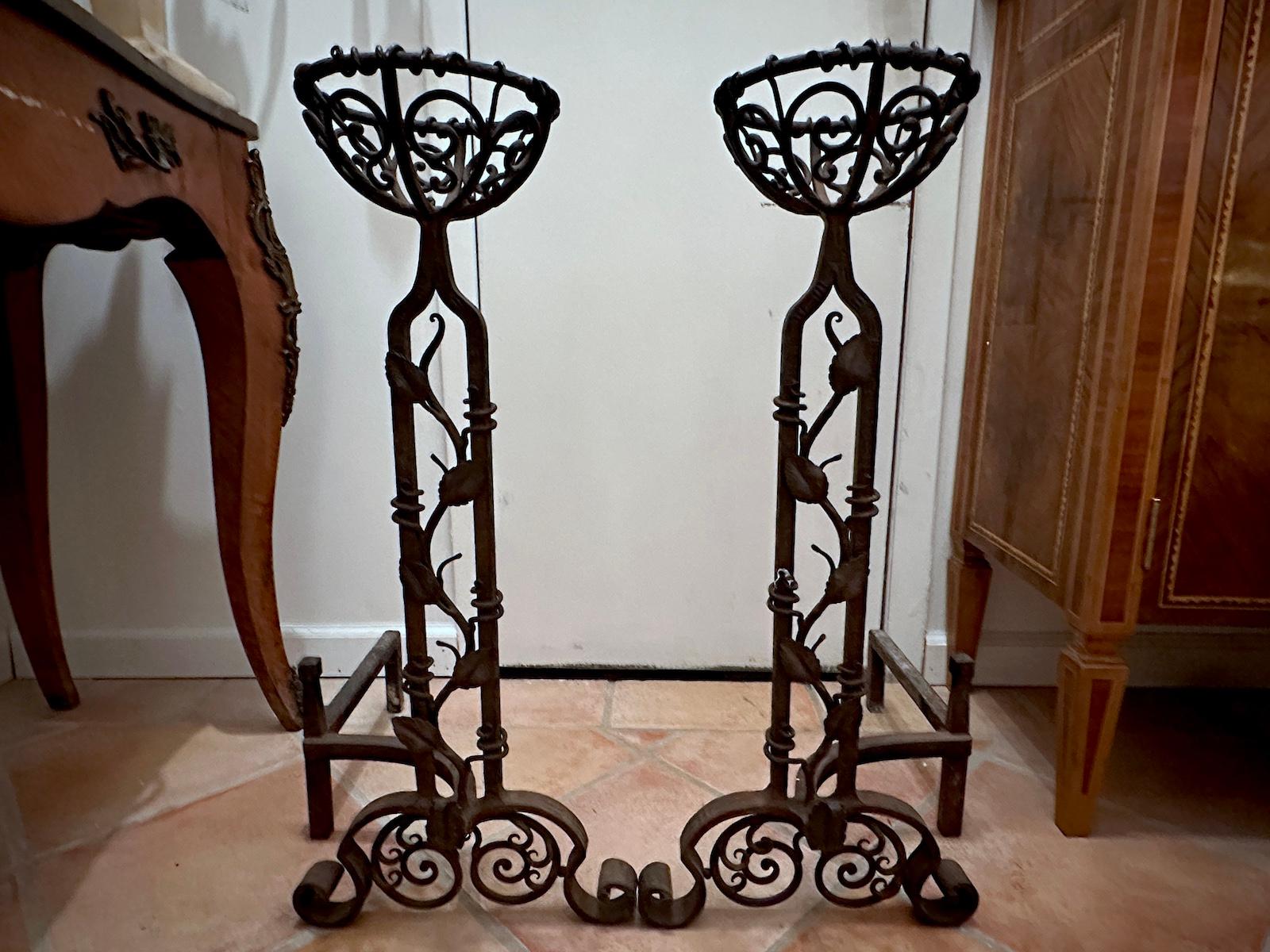 Pair of French hammered iron andirons with foliage motif.

Measurements:
Height: 28.5