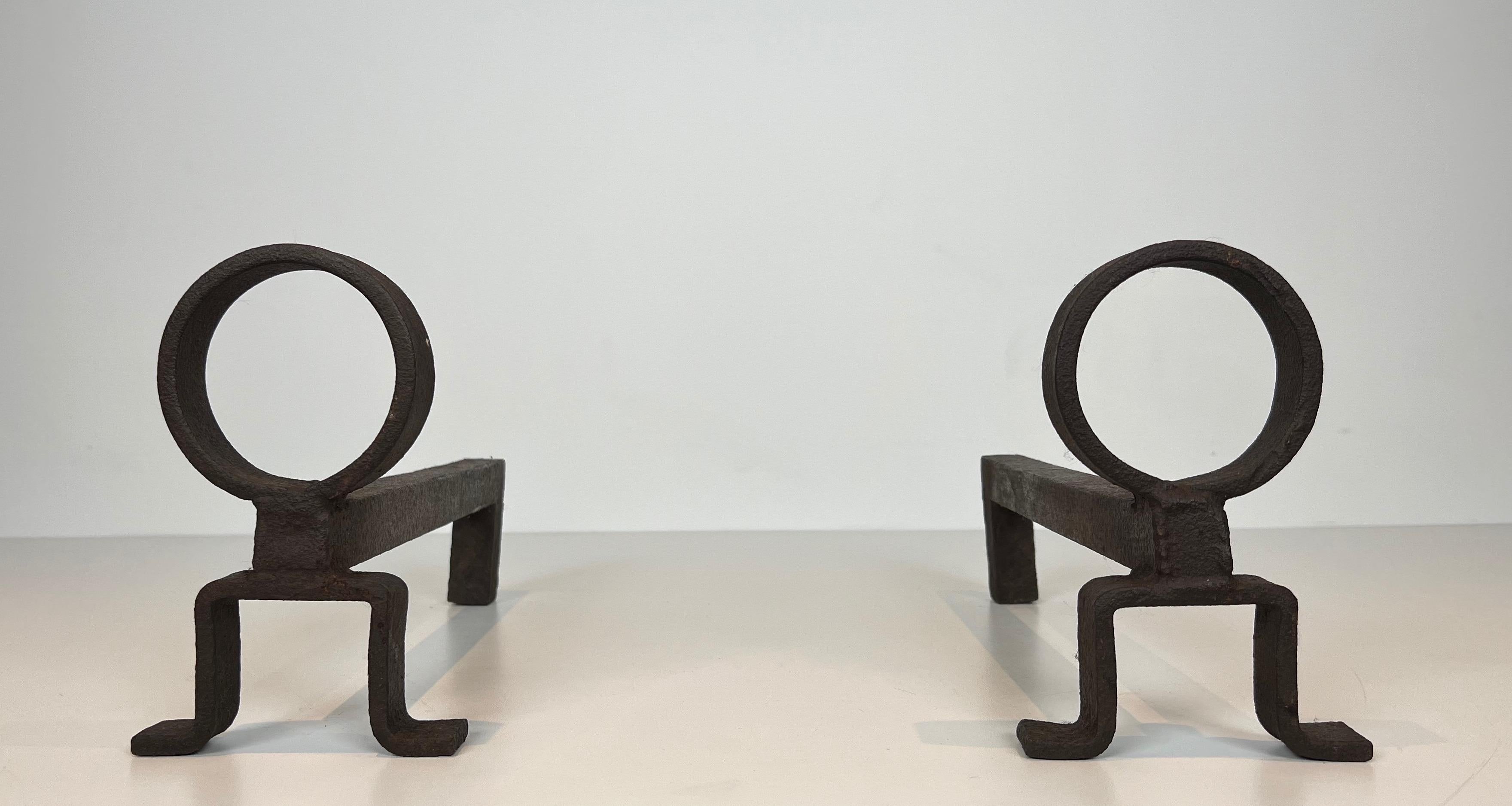 This very nice, simple and modernist pair of andirons is made of wrought iron. This is a French work in the style of famous designer Jean Royère. Circa 1950