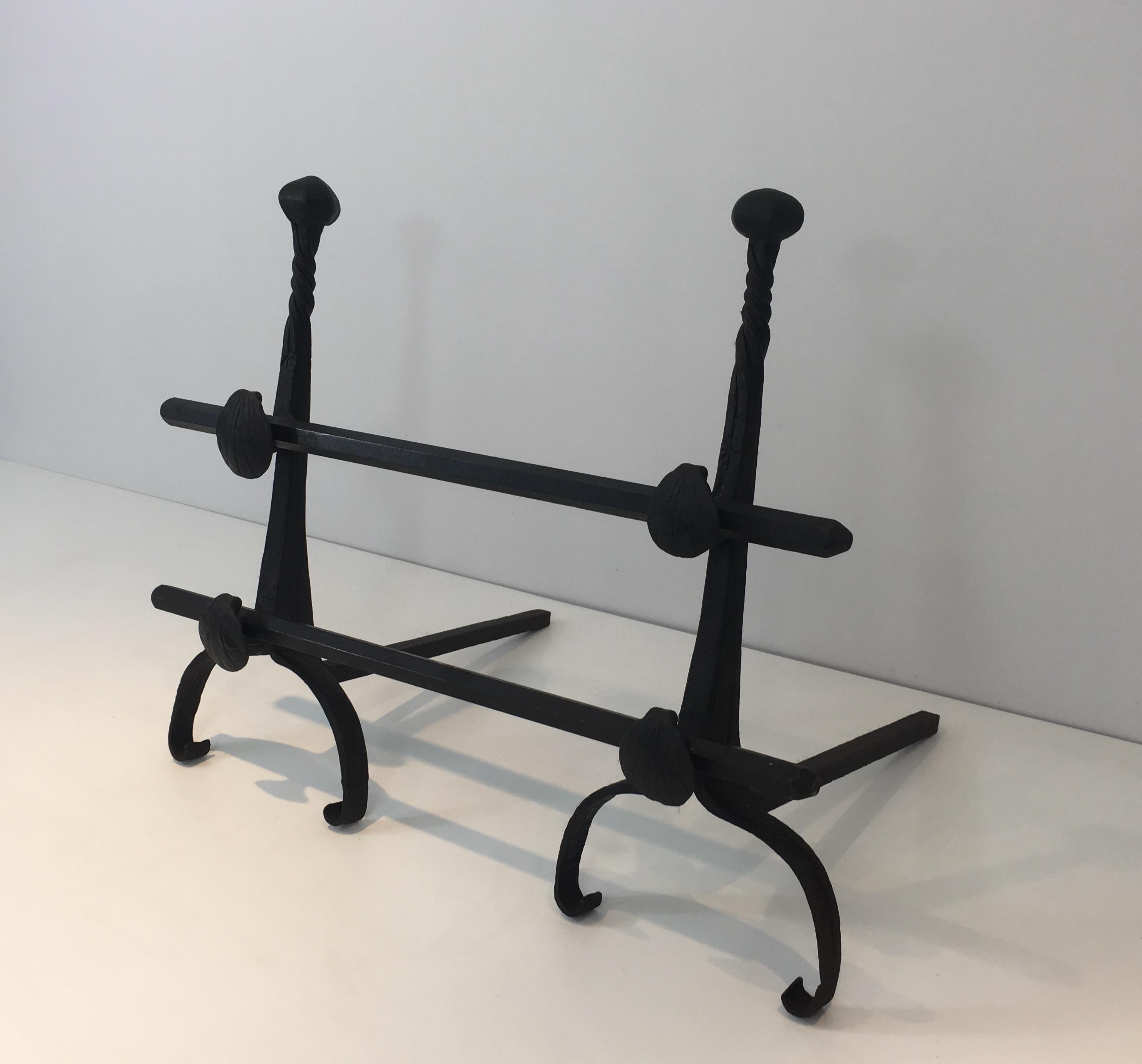 This pair of Gothic wrought Iron andirons has iron shells used as a bar holders. They are French, 19th century.