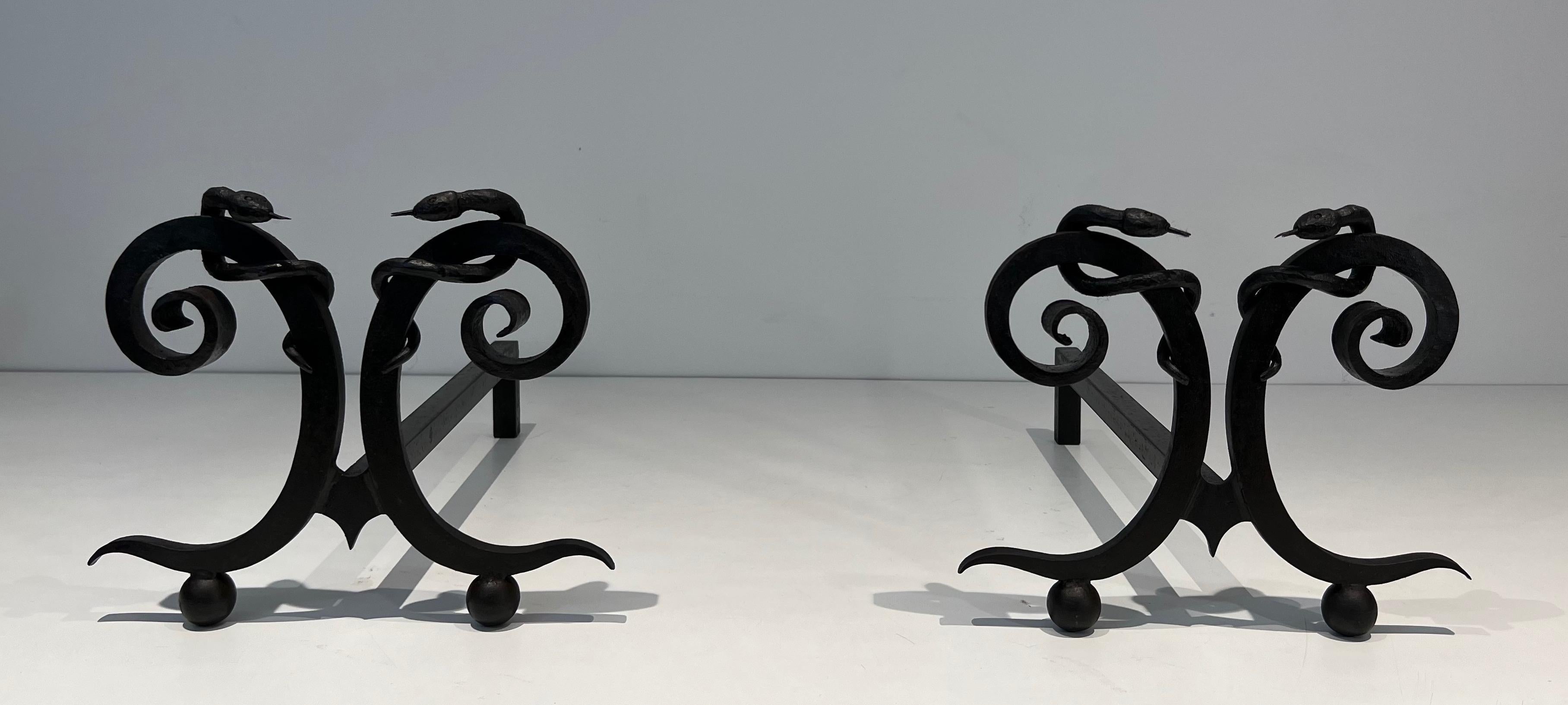 Mid-Century Modern Pair of wrought iron andirons with Snakes in the style of Edgar Brandt For Sale