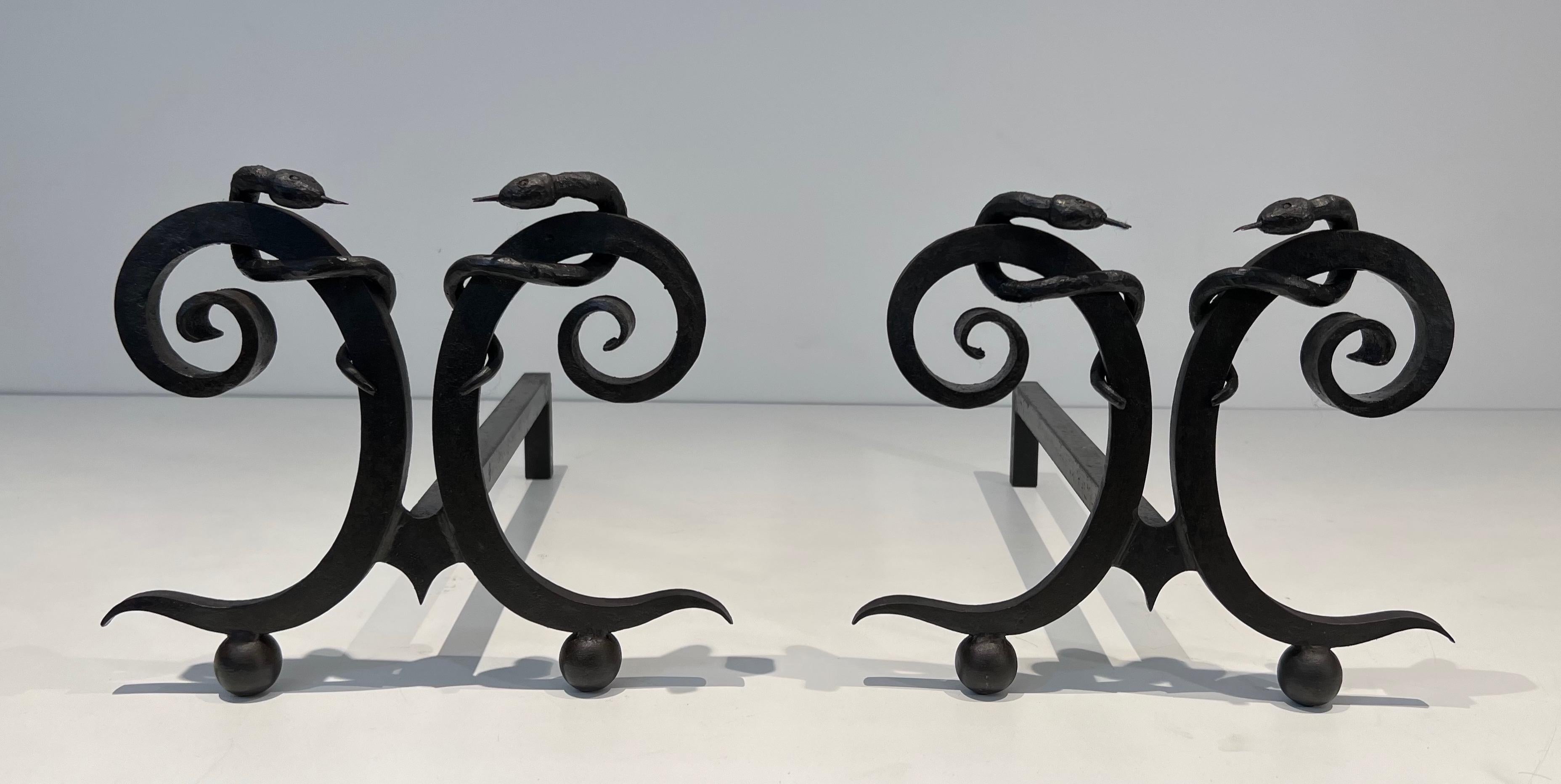 French Pair of wrought iron andirons with Snakes in the style of Edgar Brandt For Sale