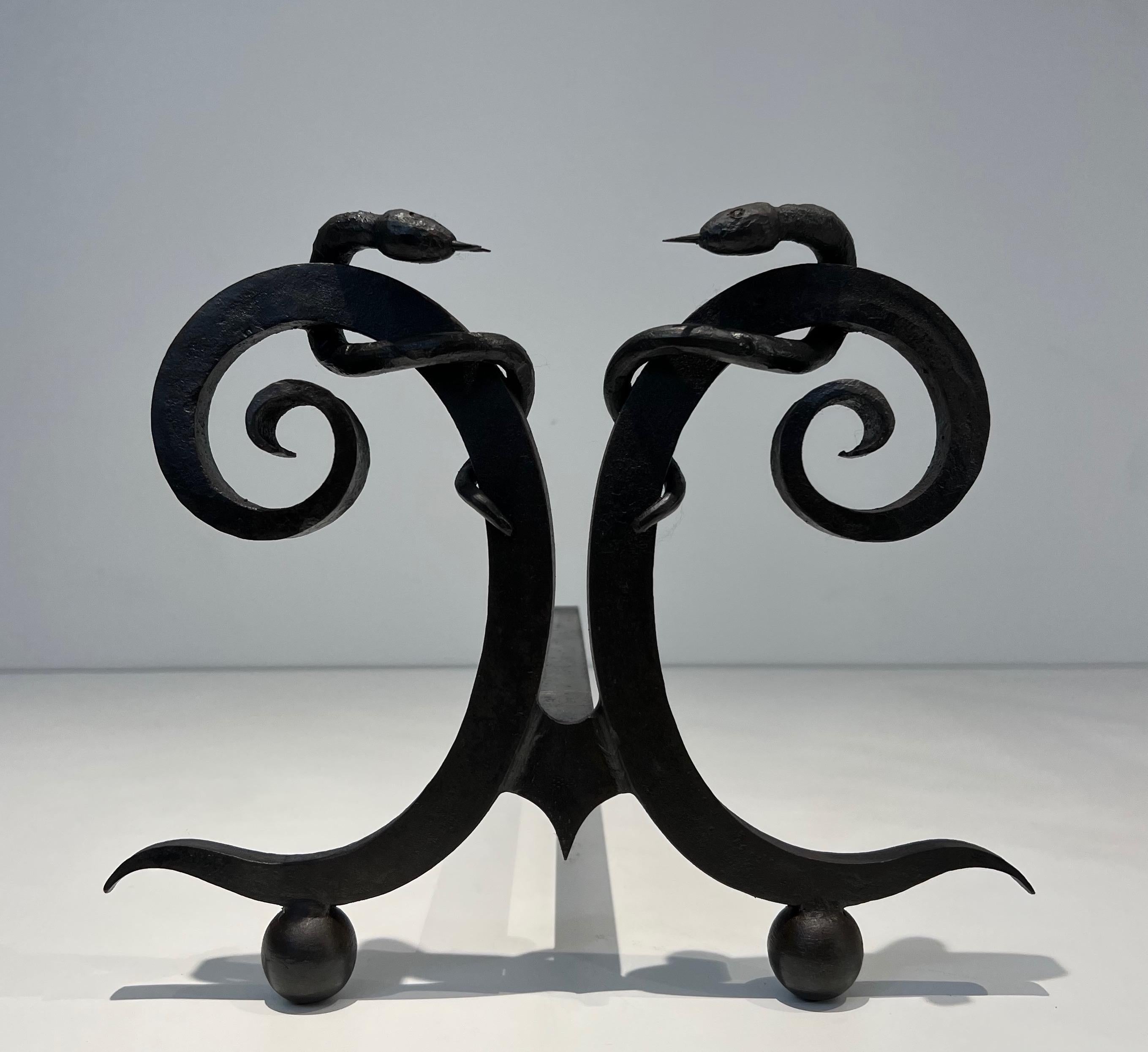 Wrought Iron Pair of wrought iron andirons with Snakes in the style of Edgar Brandt For Sale