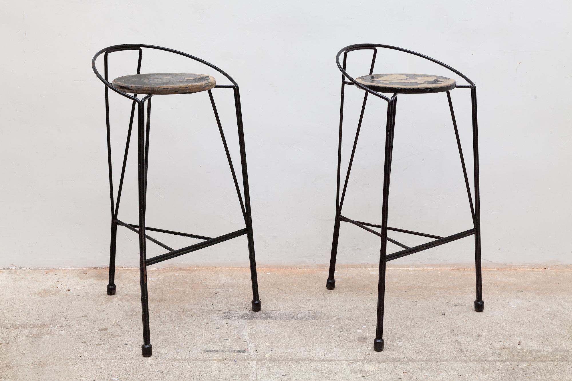 Vintage midcentury bar stools. Modernist black metal tripod wrought iron frame with rubber capped feet. Vintage patina and wear to the surface of the seat and frame. In excellent structural condition.
Dimensions: 46 W x 90 H x 40 D cm, seat 81 cm