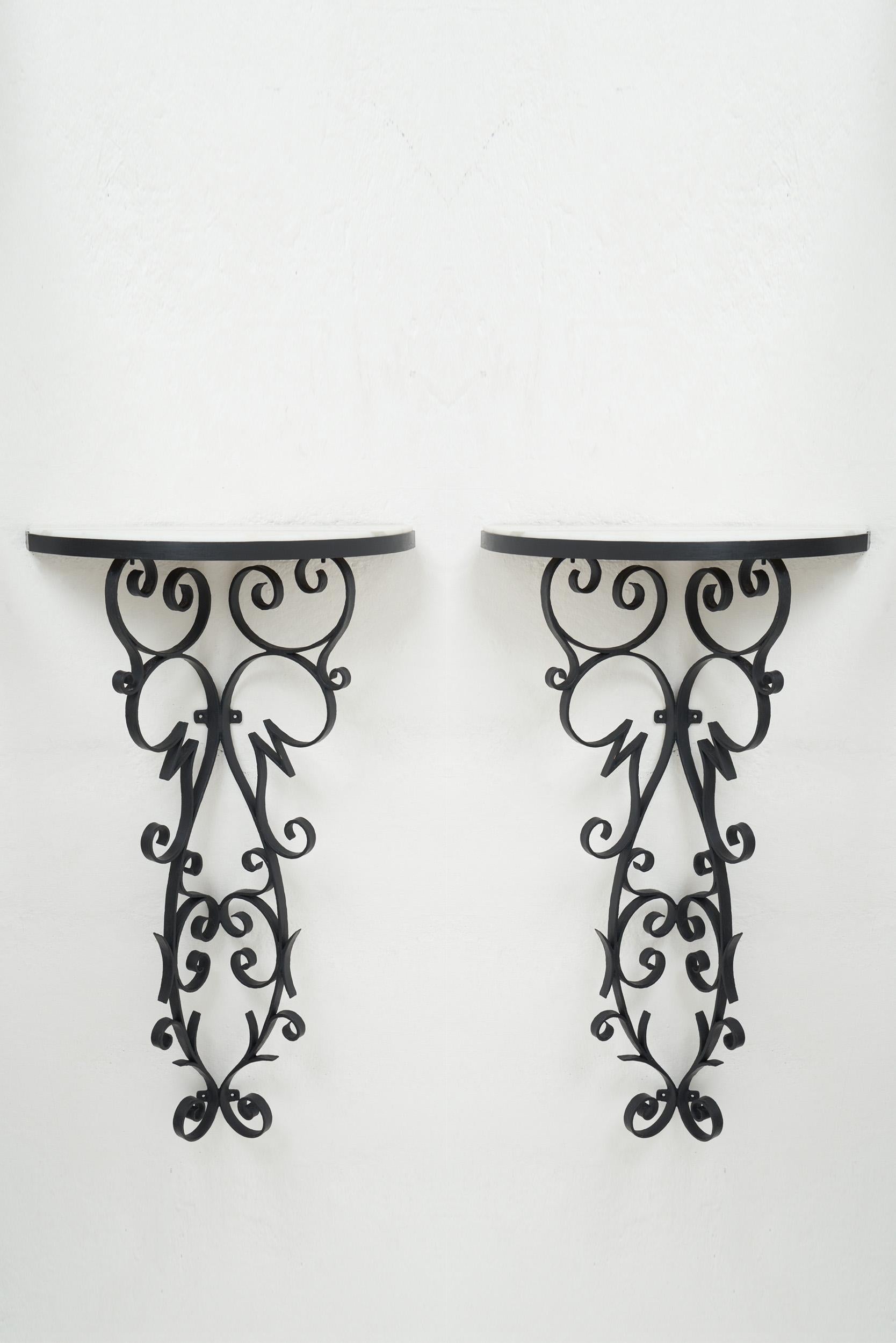 A pair of wrought iron and marble top console tables.
France, 1950s.
91 cm high by 50 cm wide by 21 cm deep.