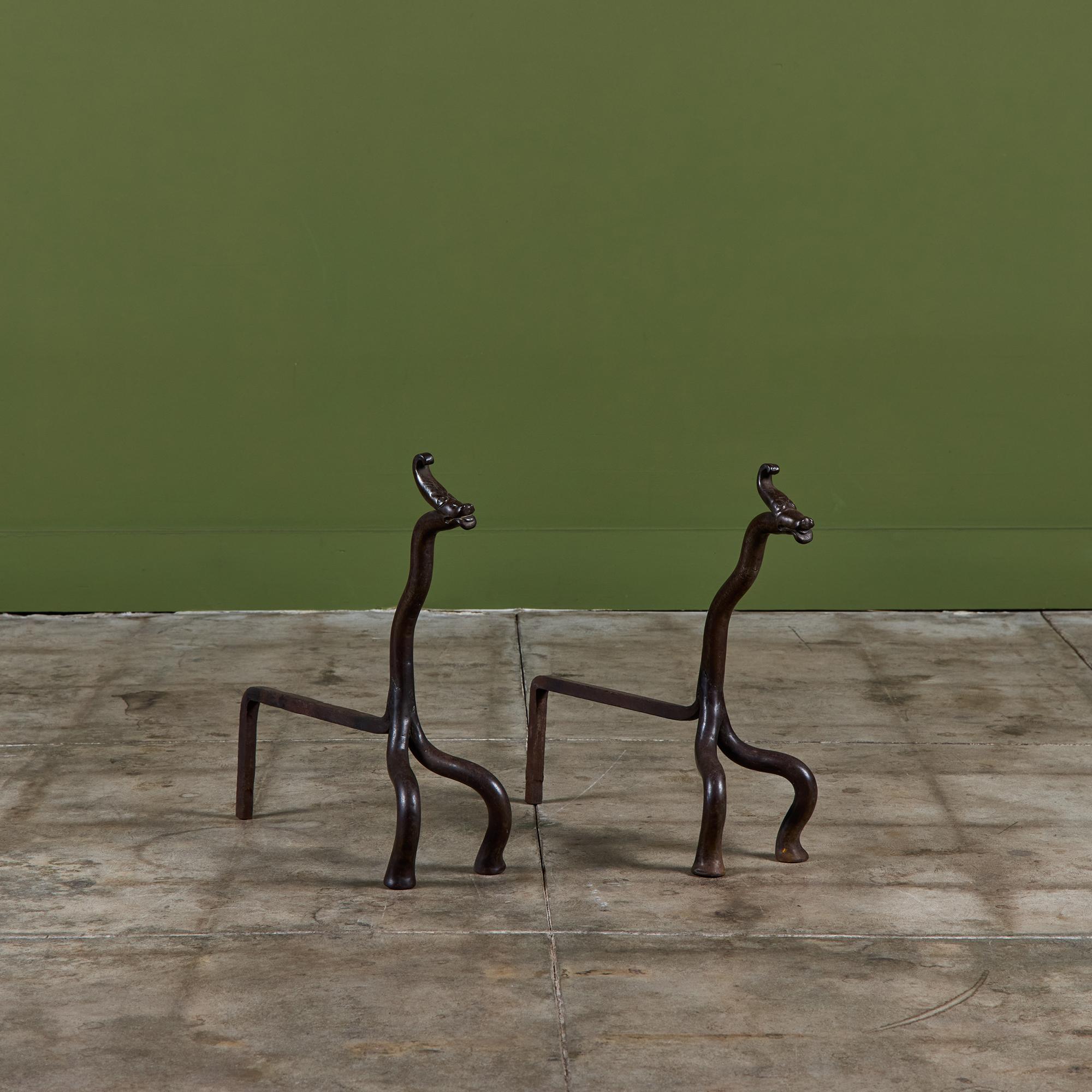 Pair of wrought iron andirons featuring dragon heads.

Dimensions
6.5