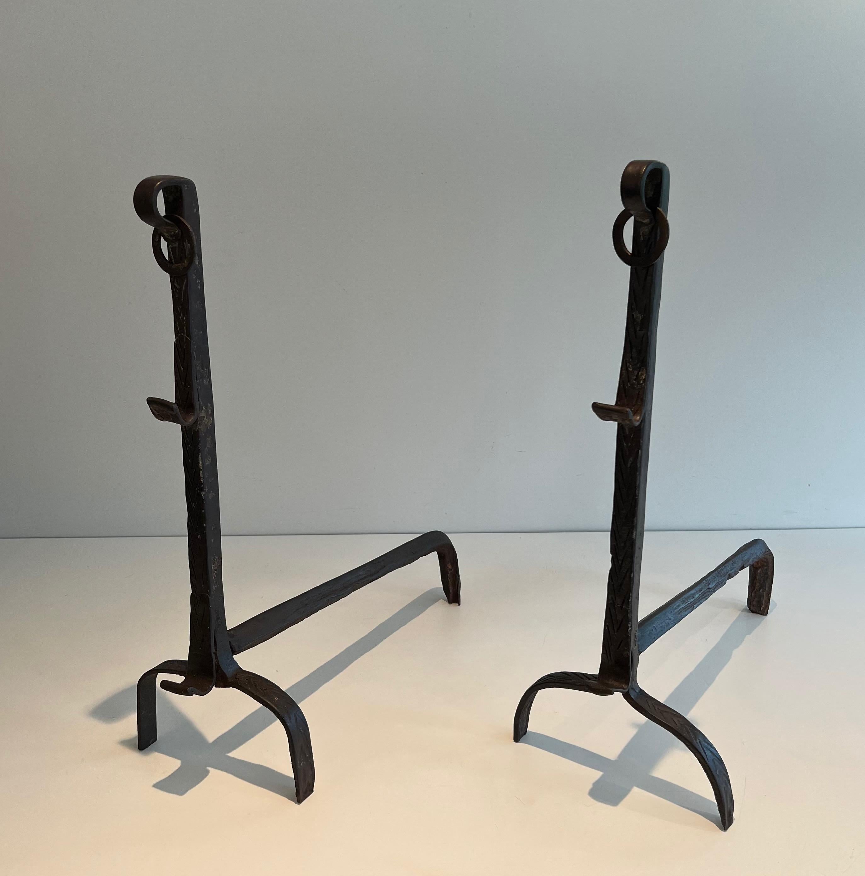 This pair of landiers are made of wrought iron. They have a rack, a 