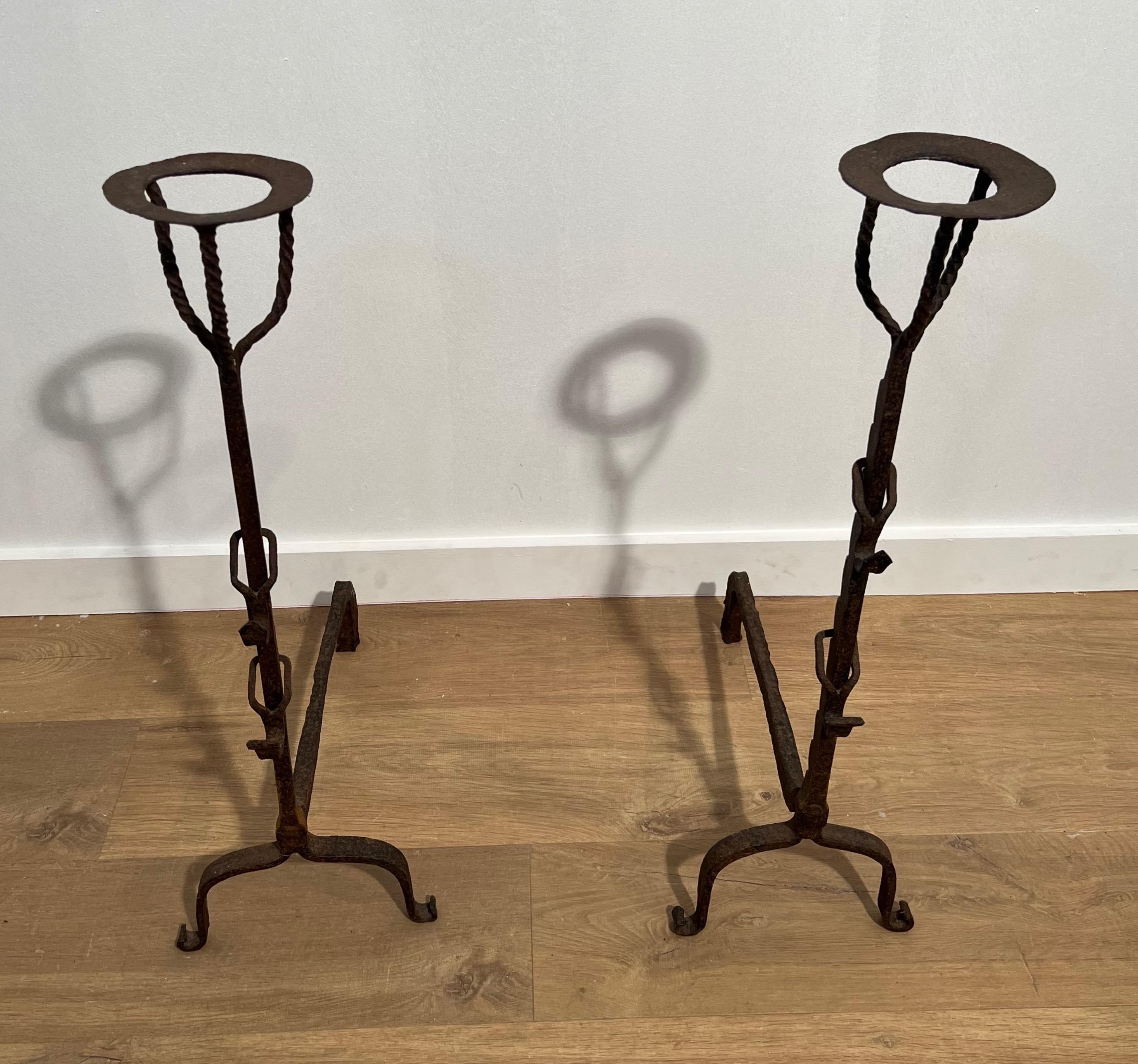 This very nice and rare pair of landiers is made of wrought iron. This is a very old and fine work. The iron is twisted on top and there is a 