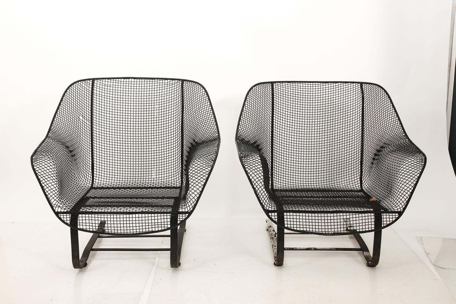 Pair of vintage bouncer chairs by Russell Woodard in the style of Sculptura for garden or outdoor use. The chairs also features wrought iron and metal mesh detail. Please note of wear consistent with age.