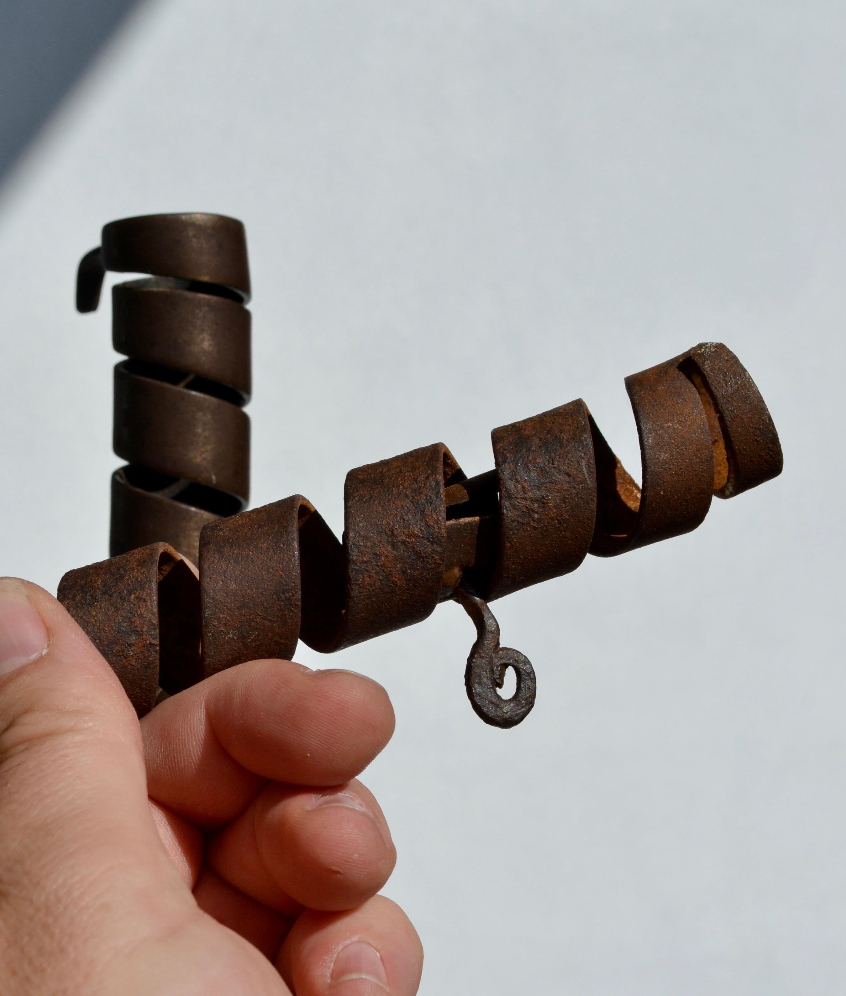 A rare and superb pair of rat de cave candleholders, hand-forged in wrought iron with wooden elements, Normandy, France, 18th century.
Crafted by hand, featuring the traditional spiral stem mechanism designed to adjust the height of the