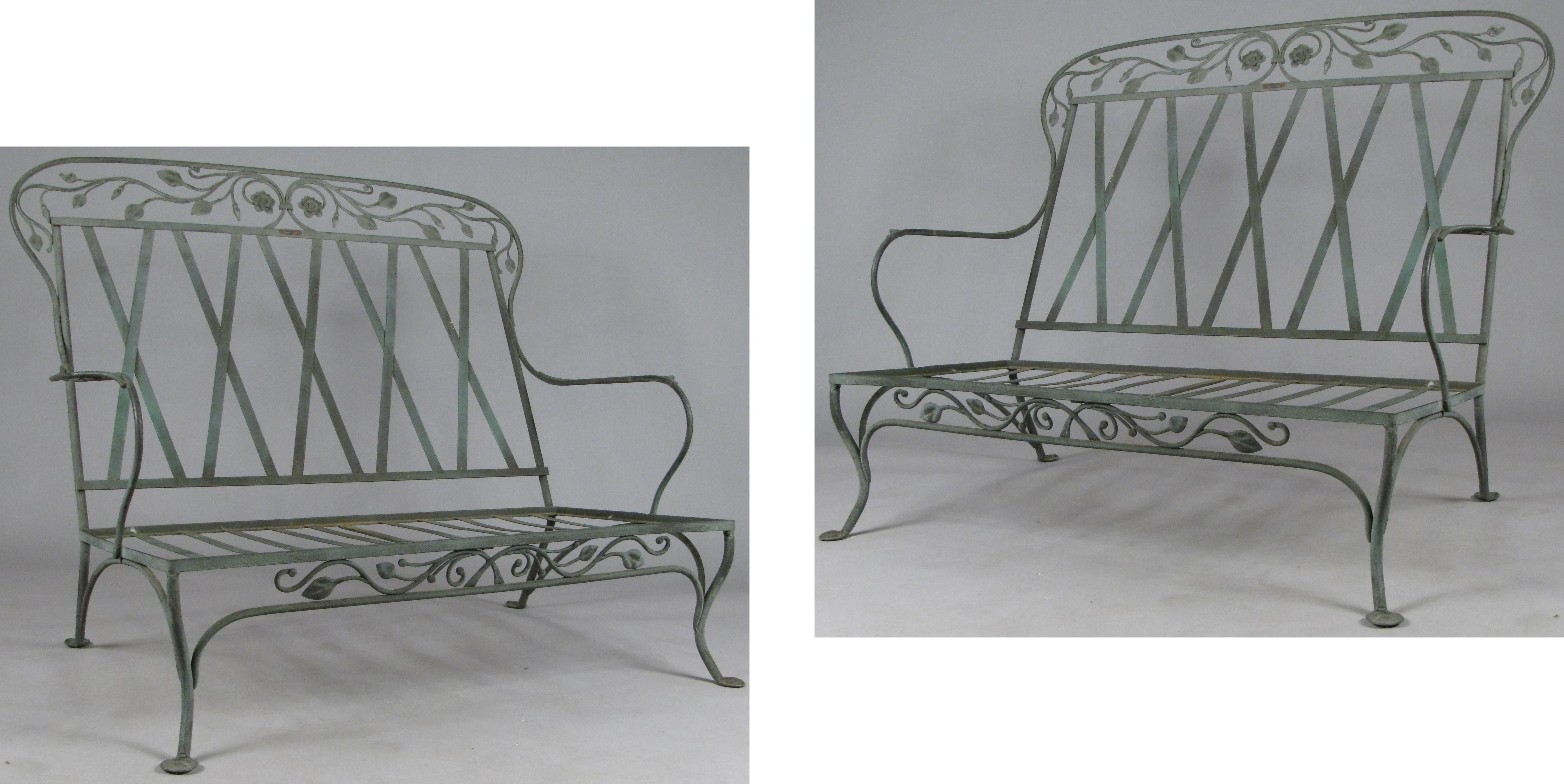 A gorgeous pair of large wrought iron settees circa 1950, by Salterini, in their blooming rose pattern. beautiful scale and details, with vine and flower details under the seat and in a large frieze above the back. wonderful aged patina. 

We also