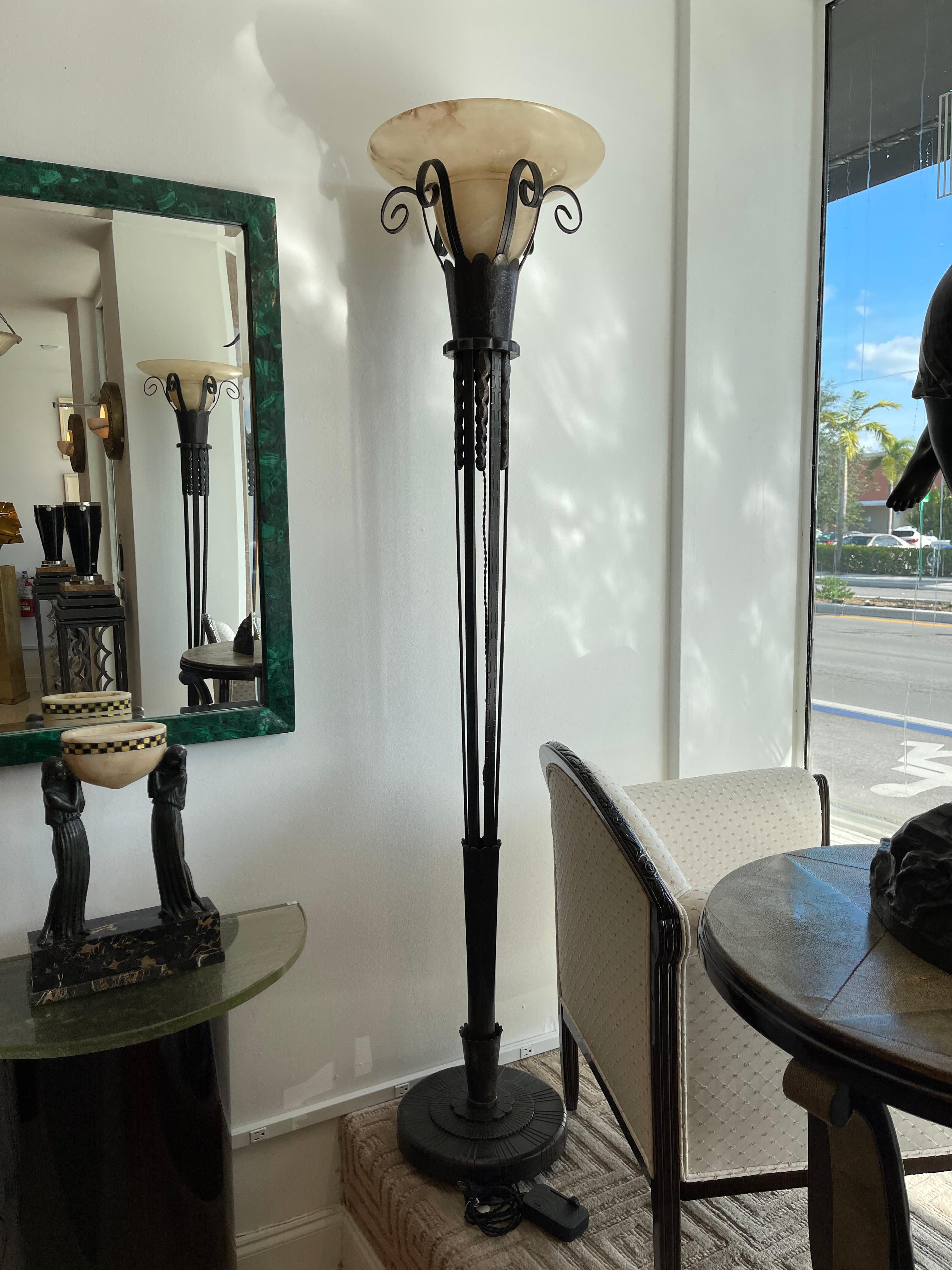 Wonderful pair of wrought iron floor lamps with alabaster shades.