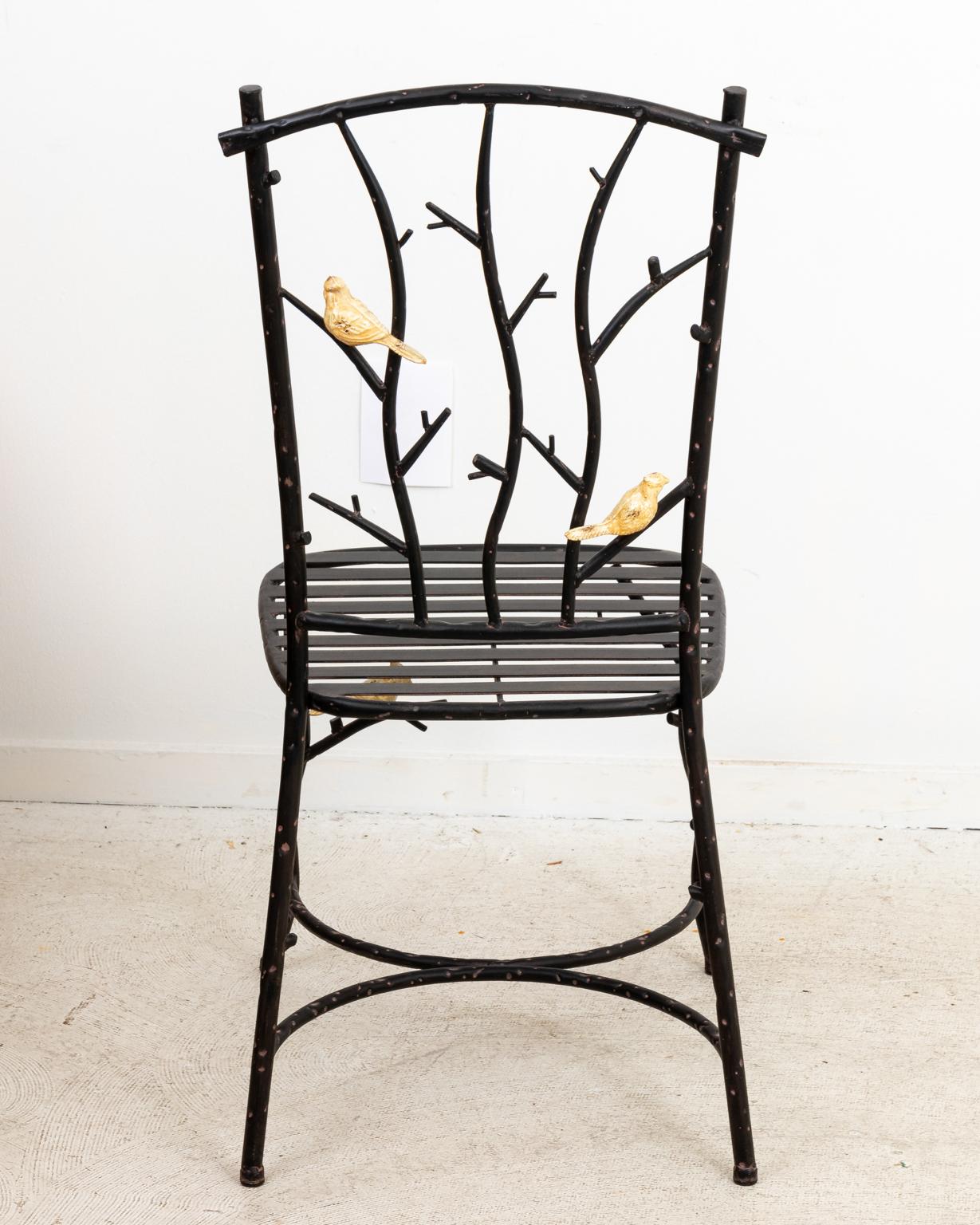 Pair of wrought iron twig chairs with birds perched throughout the frame as seen on the seat back and bottom stretcher. Please note of wear consistent with age including patina and minor finish loss.