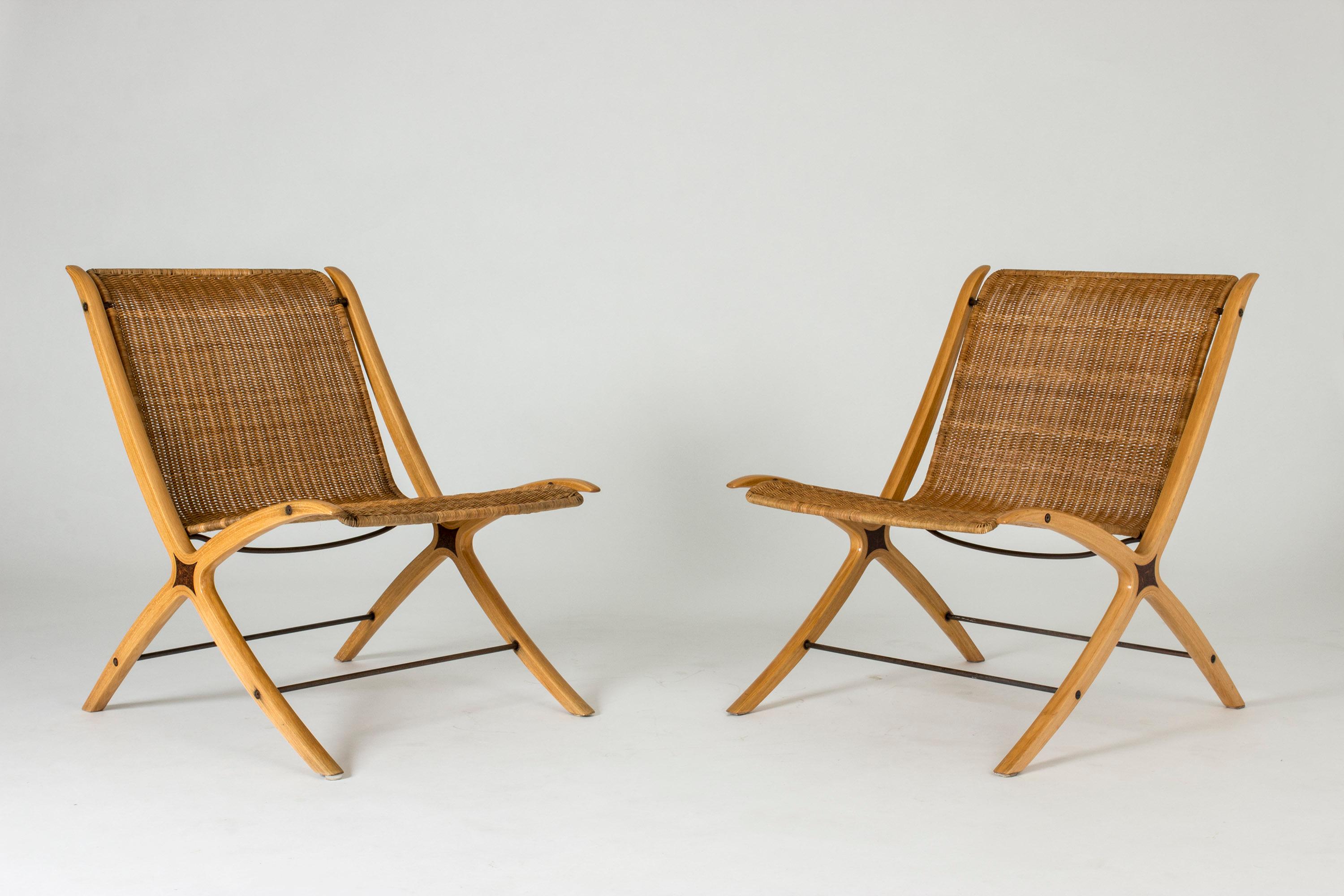 Pair of amazing “X” lounge chairs by Peter Hvidt and Orla Møllgaard, made from laminated beech and rattan. Cool detail of darker wood inlays at the cross section of the legs and back. Beautiful, unbroken lines.