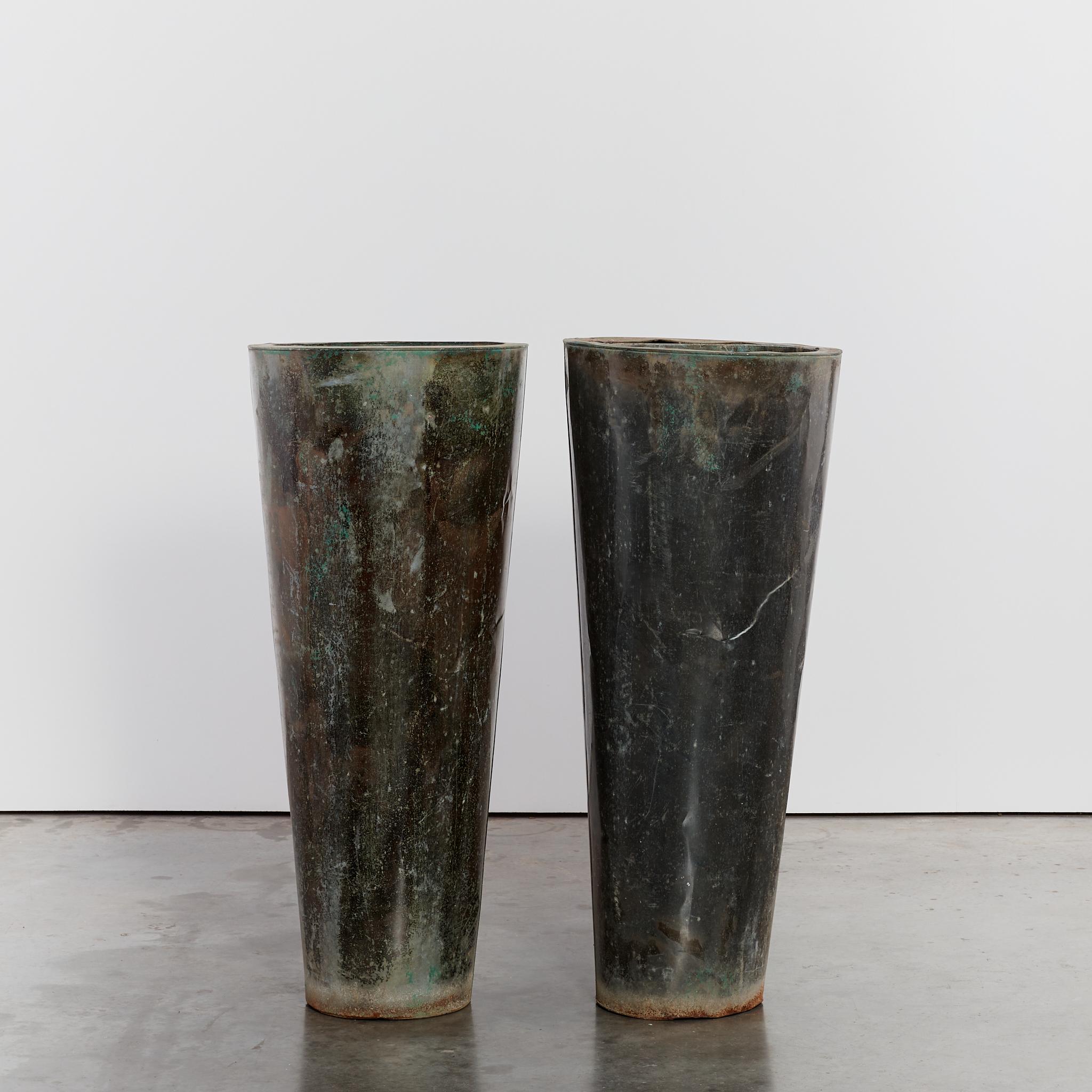 Pair of statement oversized metal planters with cylinder form and striking patina. Both come with drainage holes.

Period: Circa 1980's

Dimensions: H117 x D50cm each

Condition: Vintage condition - patina and signs of wear in keeping with age.