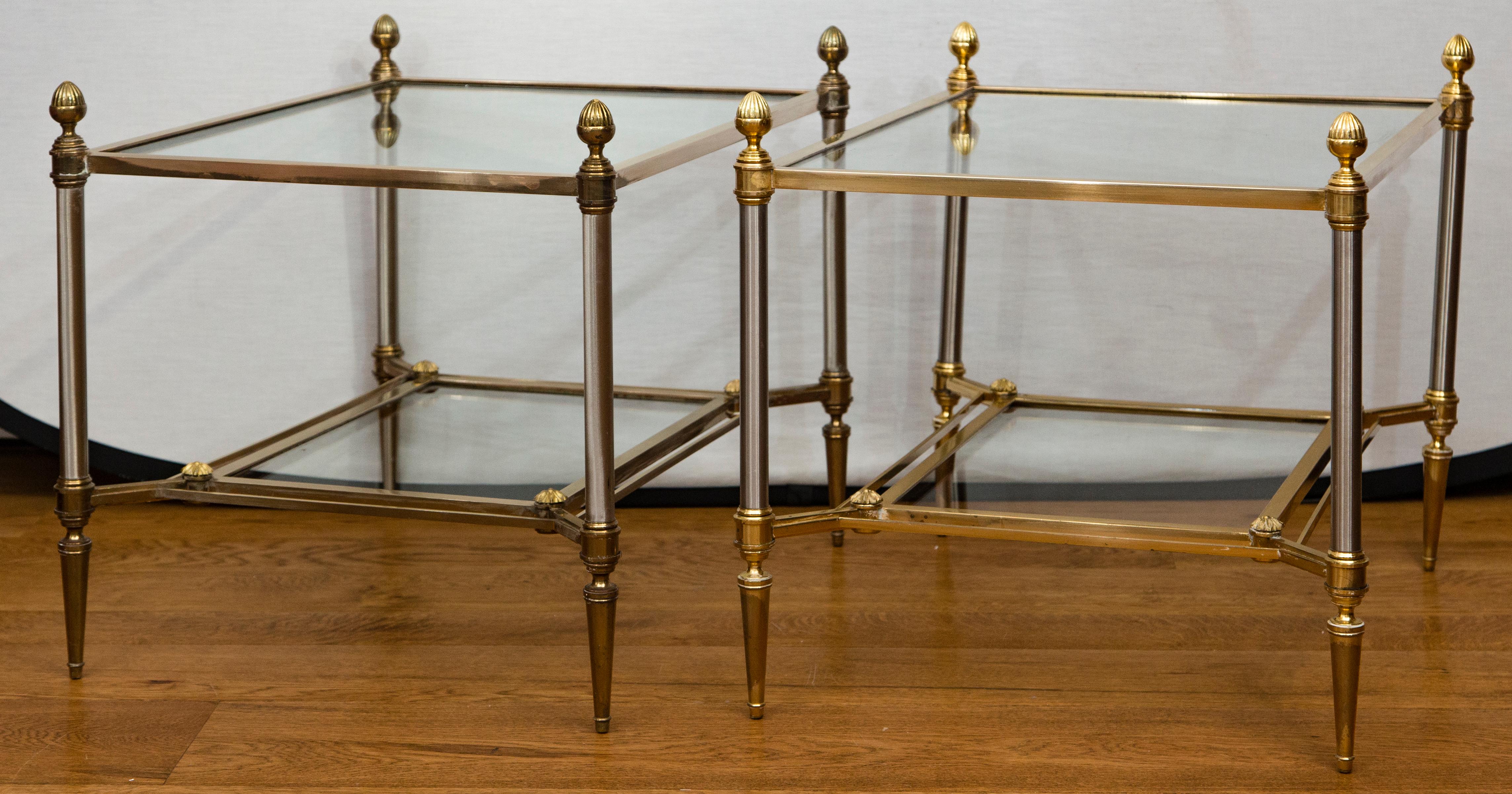 Pair of classic Maison Jansen brass and chrome two-tier tables with acorn toupie embellishments 
Brass is unlacquered and both are now polished to match the lighter one shown.  We showed one unplolished  table next to the polished table.   The satin