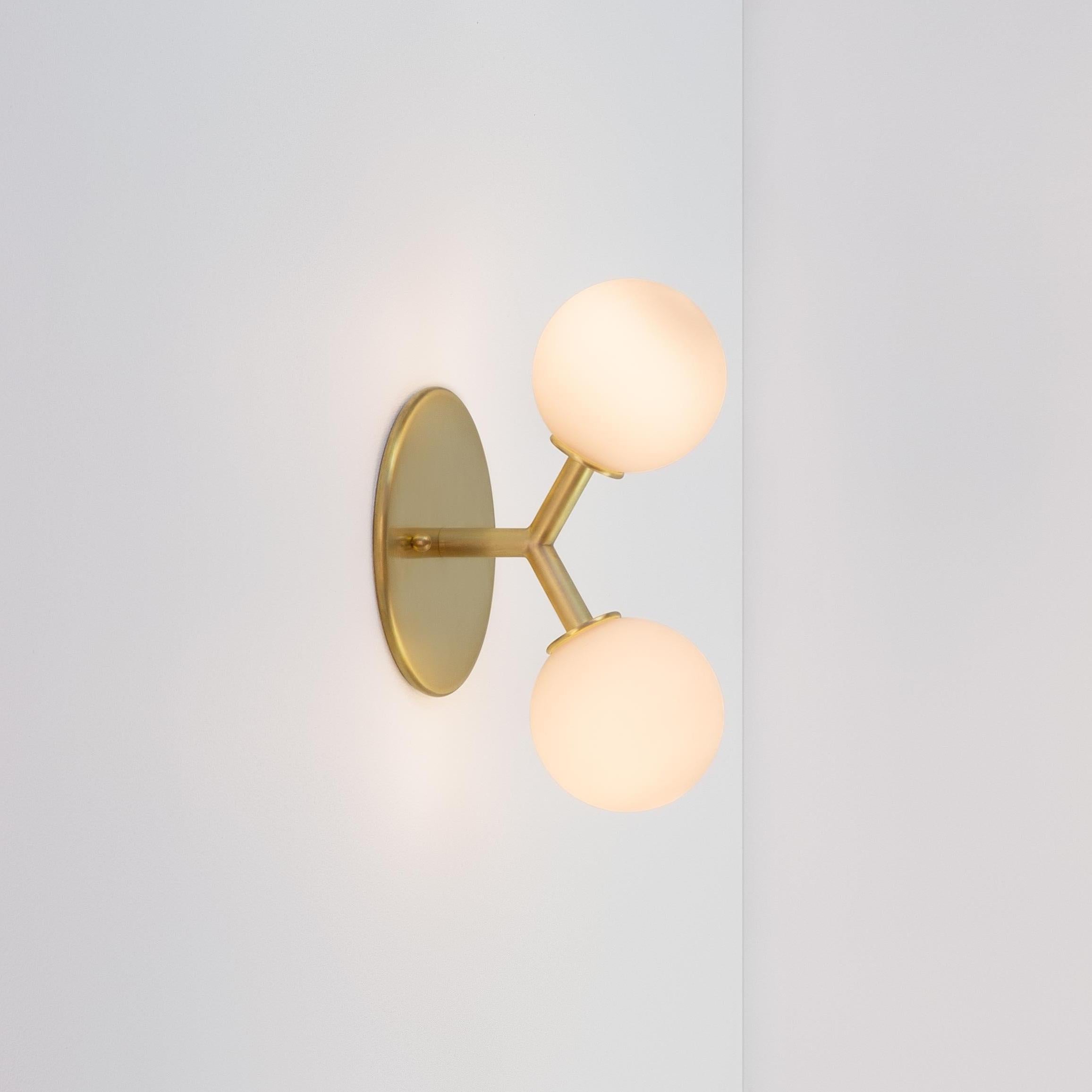 This listing is for 2x Y Sconce in Brass designed and manufactured by Research Lighting.

Lead Time: ~8 Weeks
Materials: Brass & Glass
Finish: Raw Brushed Brass 
Electronics (per fixture): 2x G9 Sockets, 2x 2.5 Watt LED Bulbs (included), 500