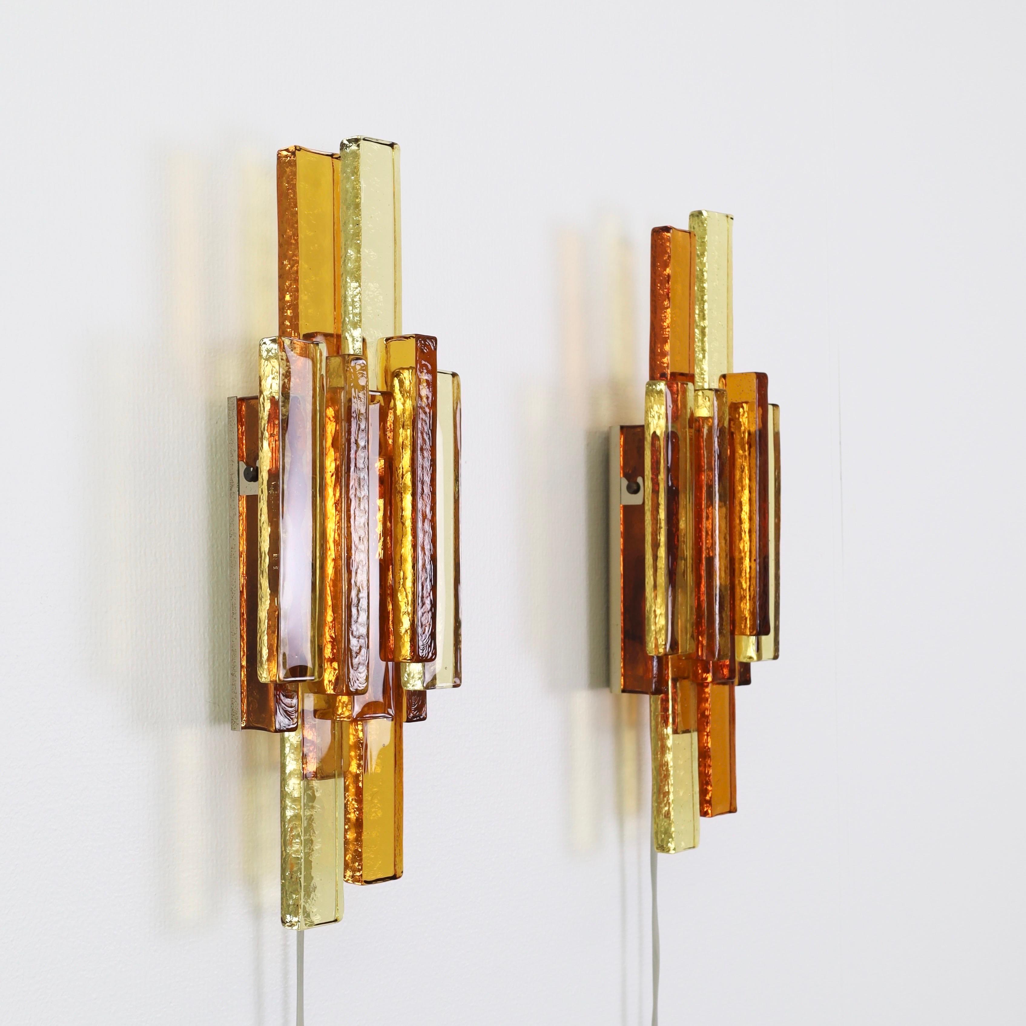 Pair of Yellow and Amber Glass Sconces made by Svend Aage Holm Sørensen in the 1960s. An impressive set for a beautiful space.

* A pair (2) of sconces with a brass base and shades pieced together by thick textured yellow and amber glass bricks
*