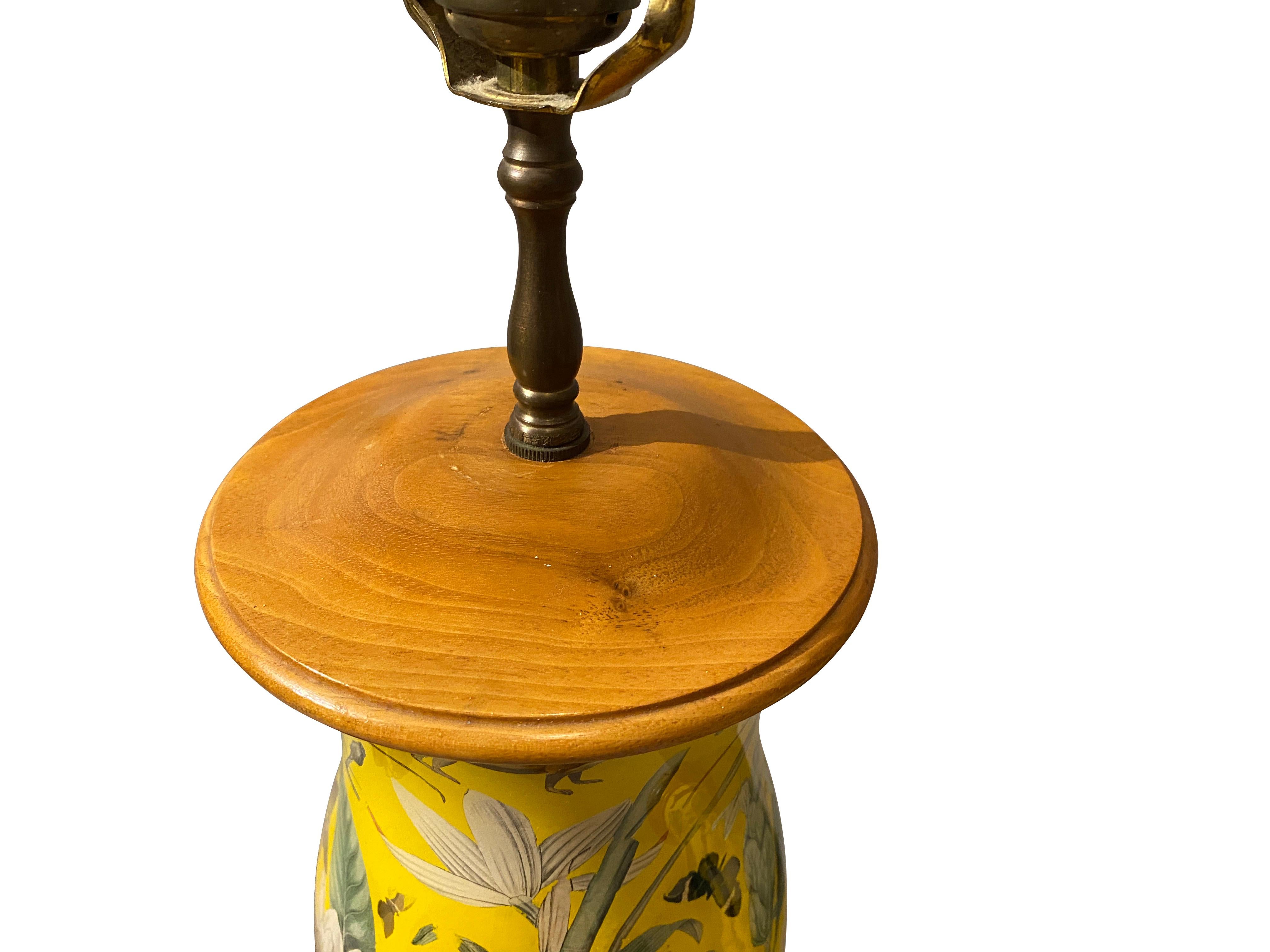 Hurricane shade form with wood fittings. Decorated with birds and animals on a bright yellow ground.
